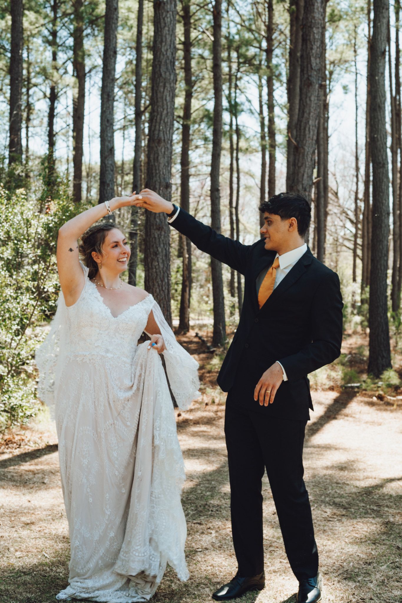 A documentary-style collage of four wedding moments in a sunlit pine forest setting between a couple in white and black.