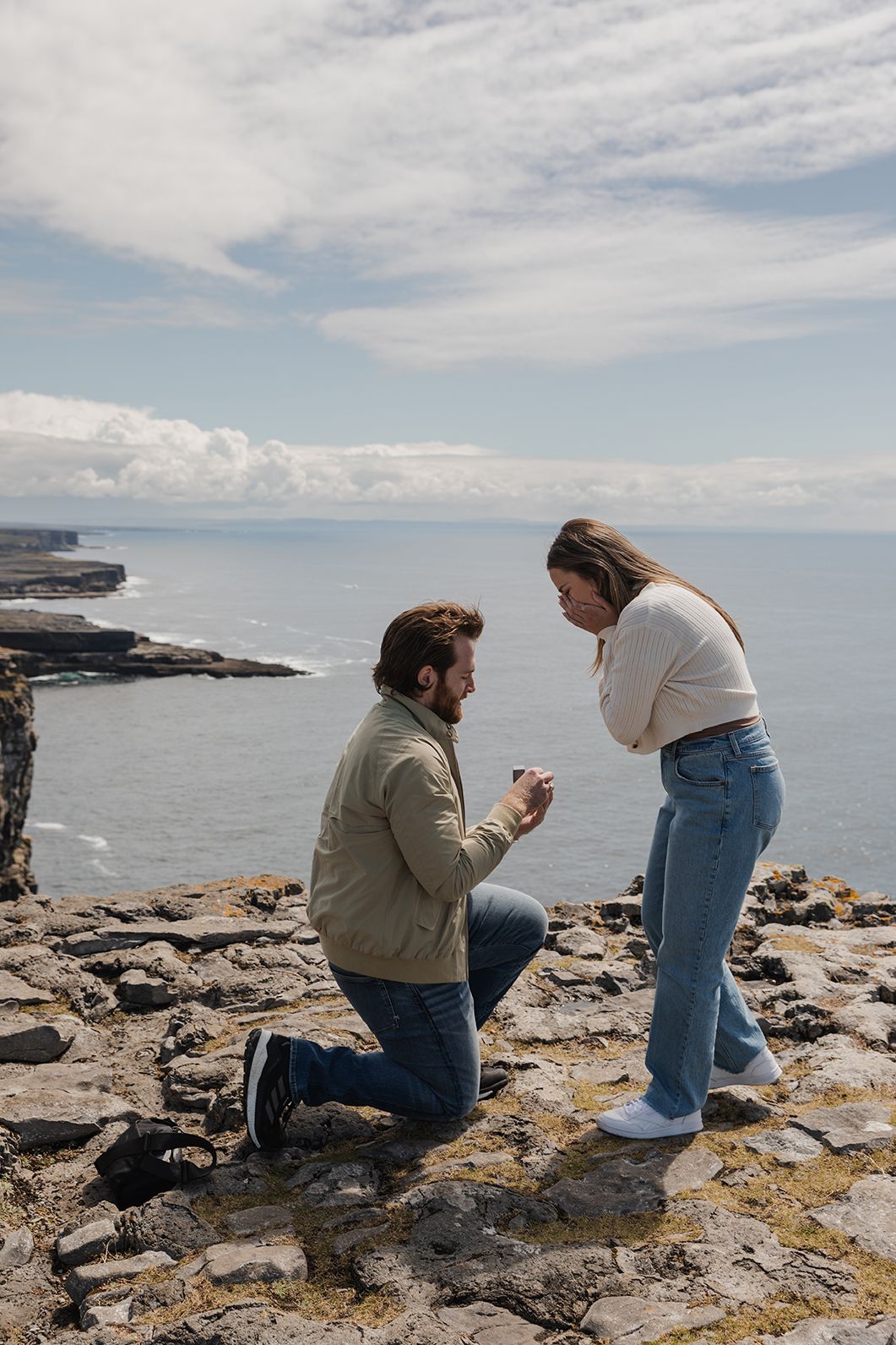 man is proposing to his girlfriend at the top of Dún Aonghasa – Ancient Stone Fort on Inis Mor (Inishmore) island in county Galway