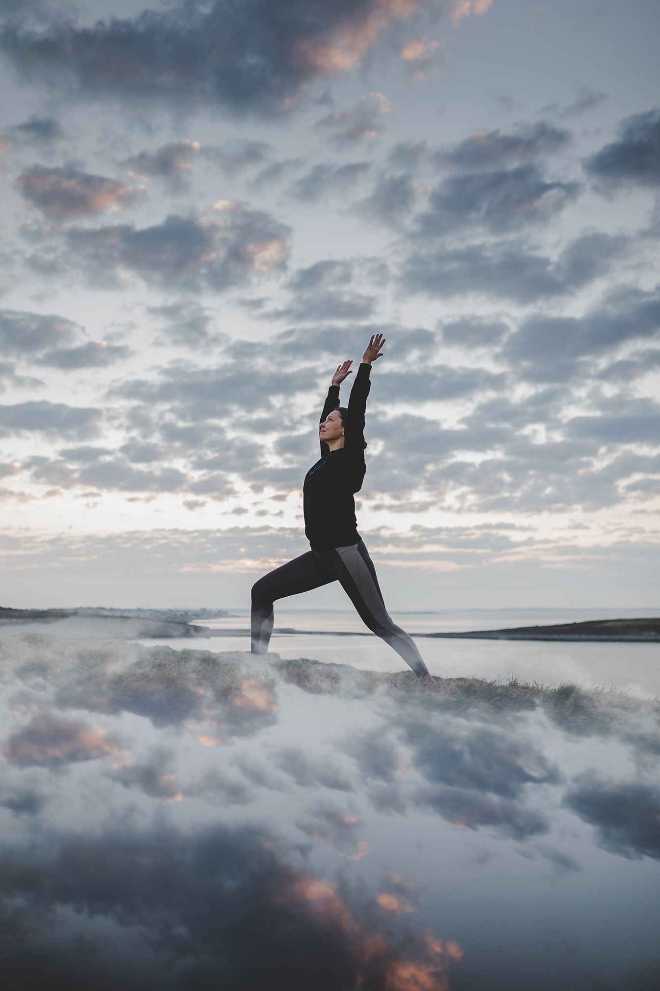 woman standing in a yoga pose during her branding photo session in Silverstrand, Galway during sunrise