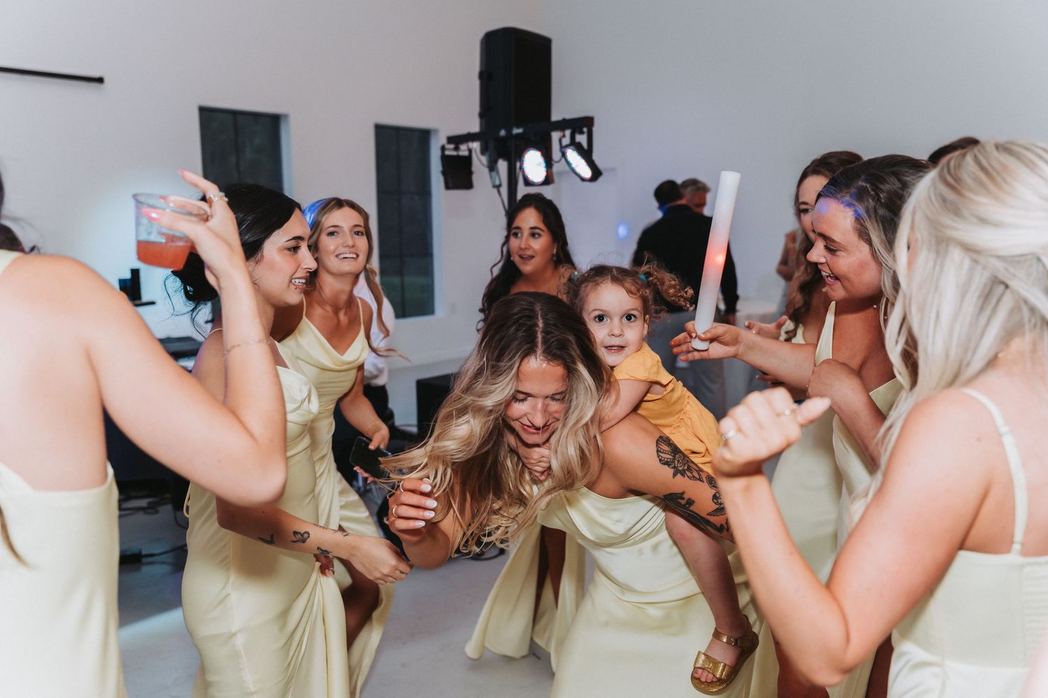Collage of candid celebratory moments showing people laughing and dancing together at a lively party or reception.