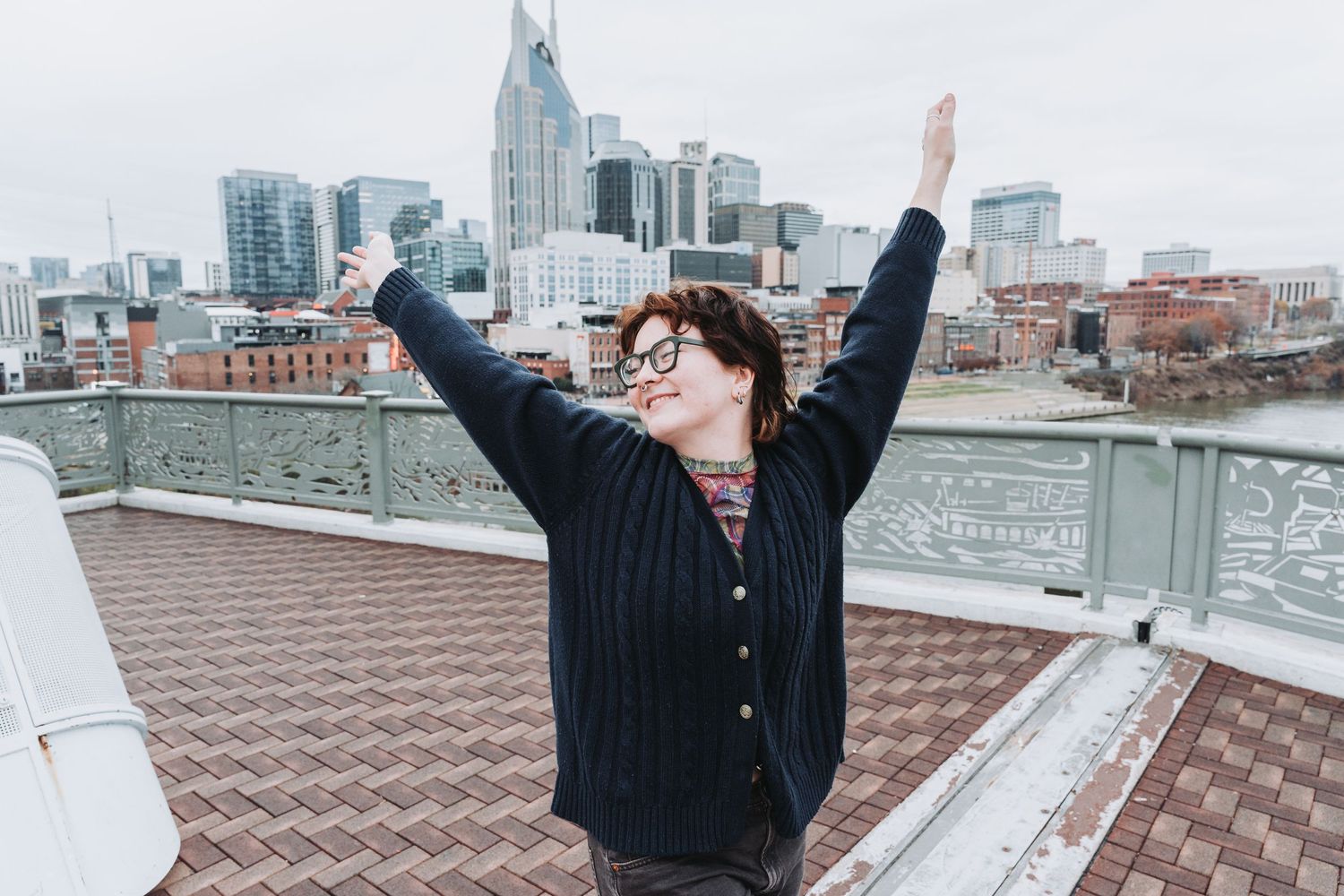 Joyous rooftop celebration with Nashville cityscape in background.