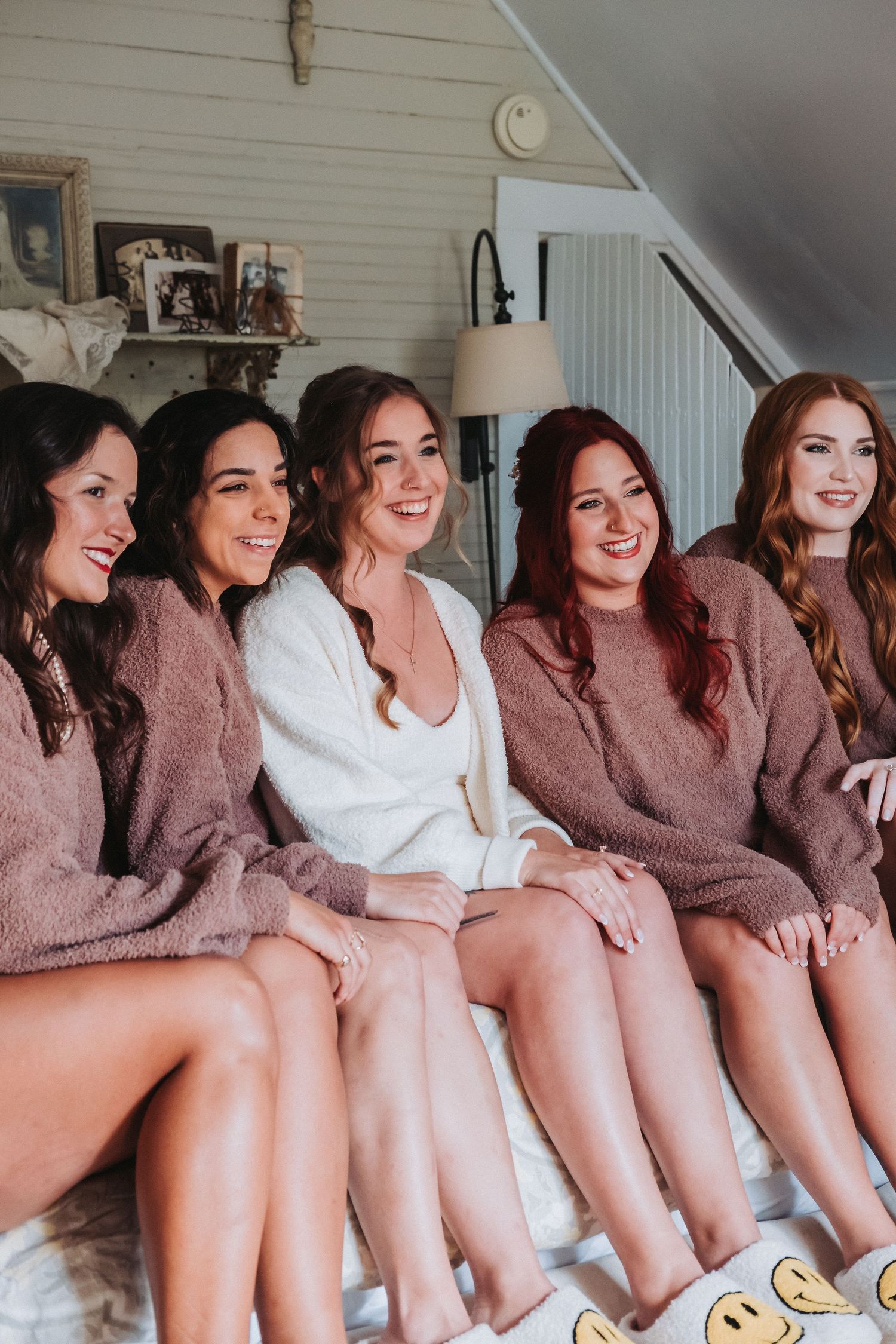 Several people wearing cozy brown and white sherpa pullovers sit together on a couch, creating a coordinated group scene.