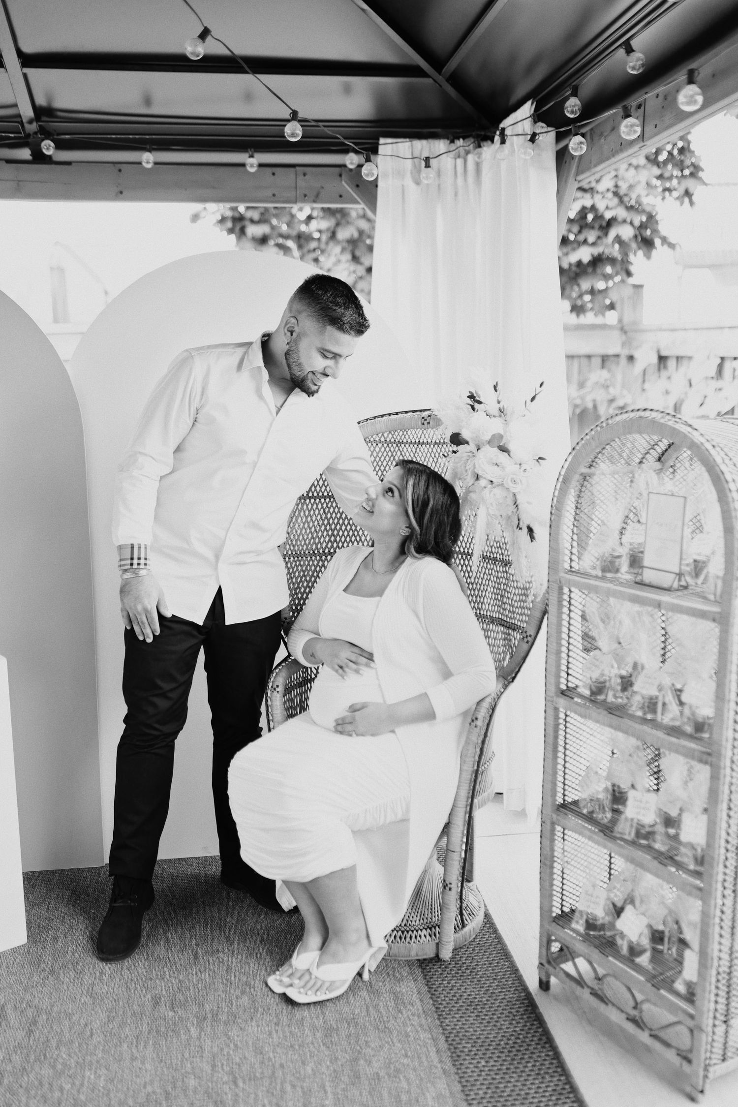 A romantic black and white moment between two people in a vintage-style interior setting.