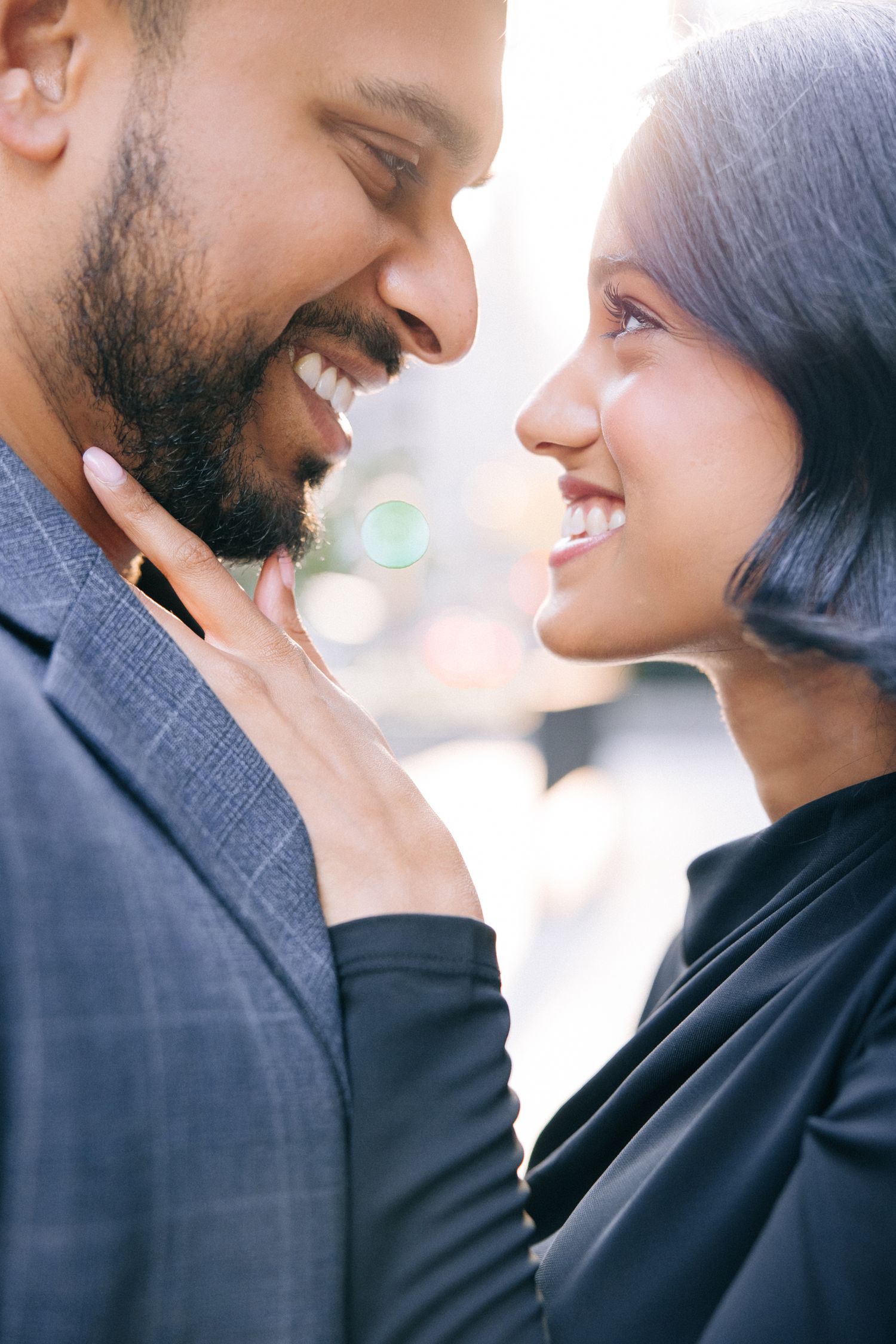 A close-up of a loving couple sharing a tender moment and smiling at each other.