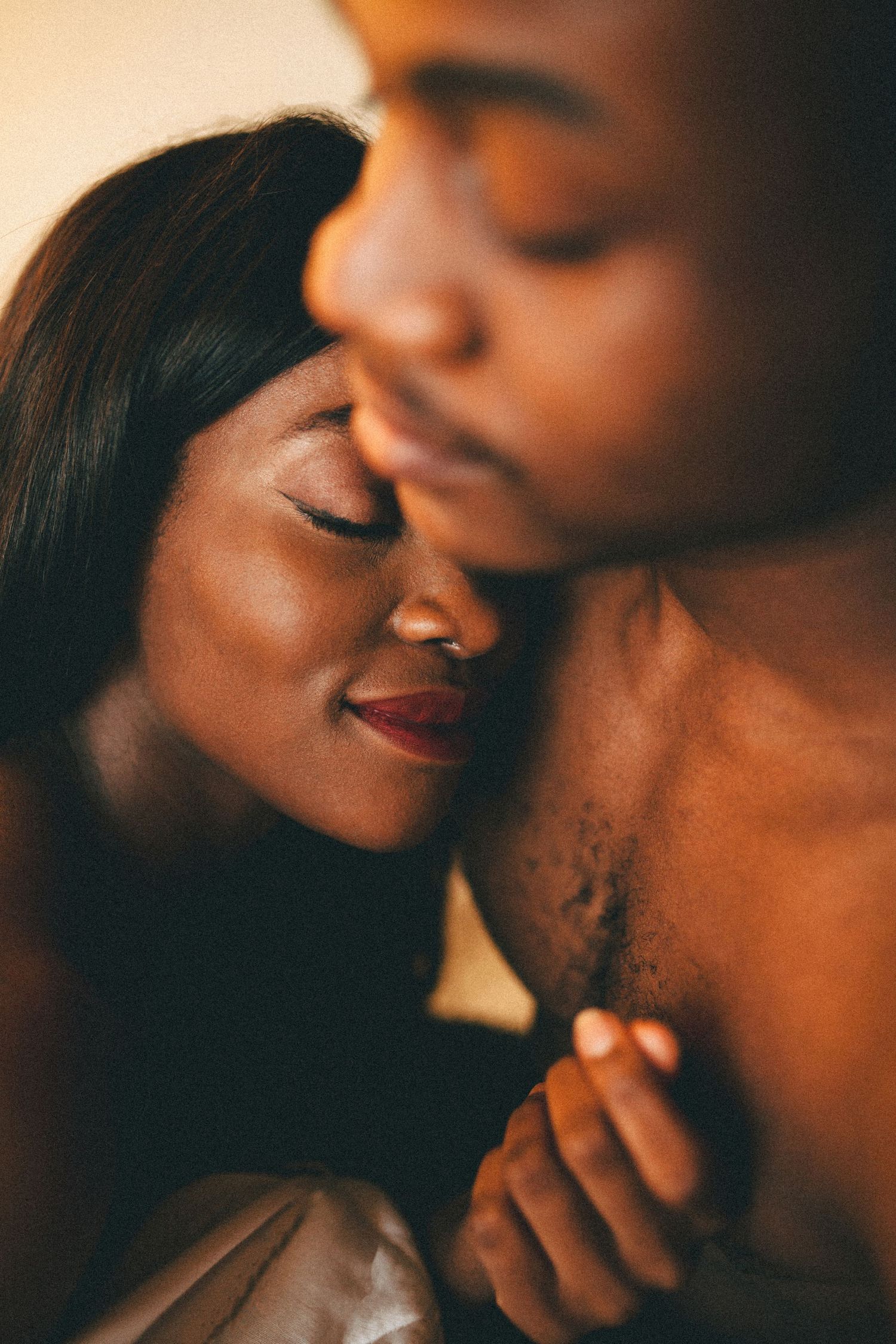 An intimate close-up portrait captures a tender romantic moment.