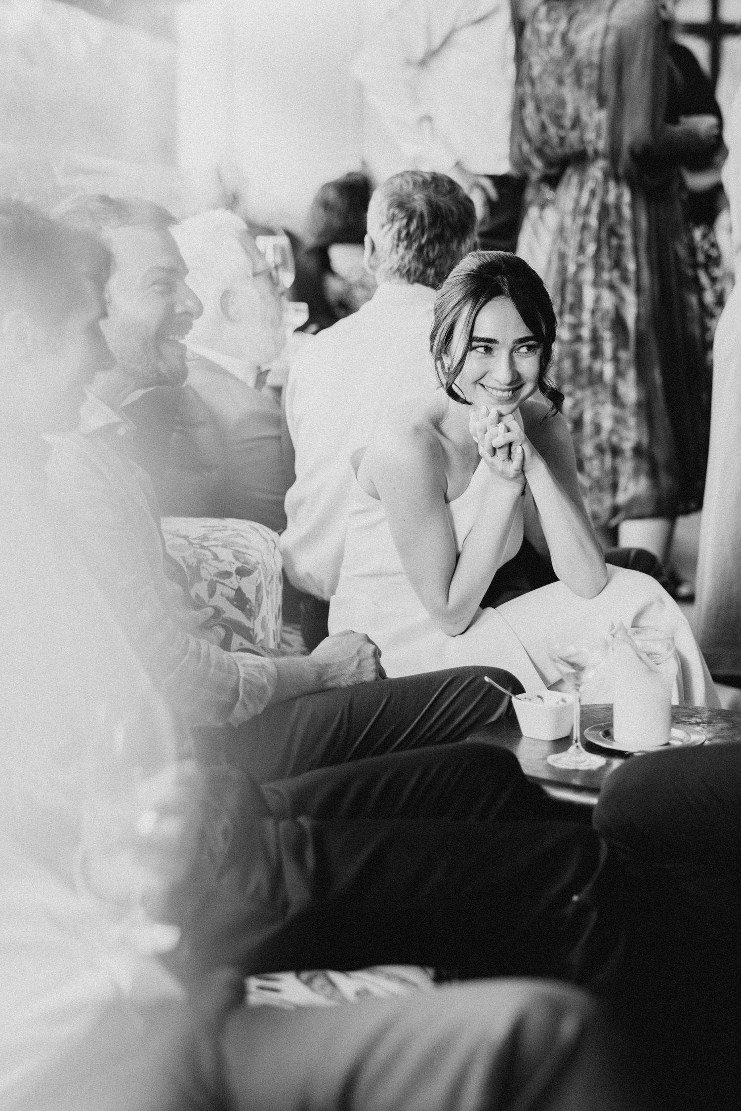 Black and white photo of guests enjoying a wedding reception.