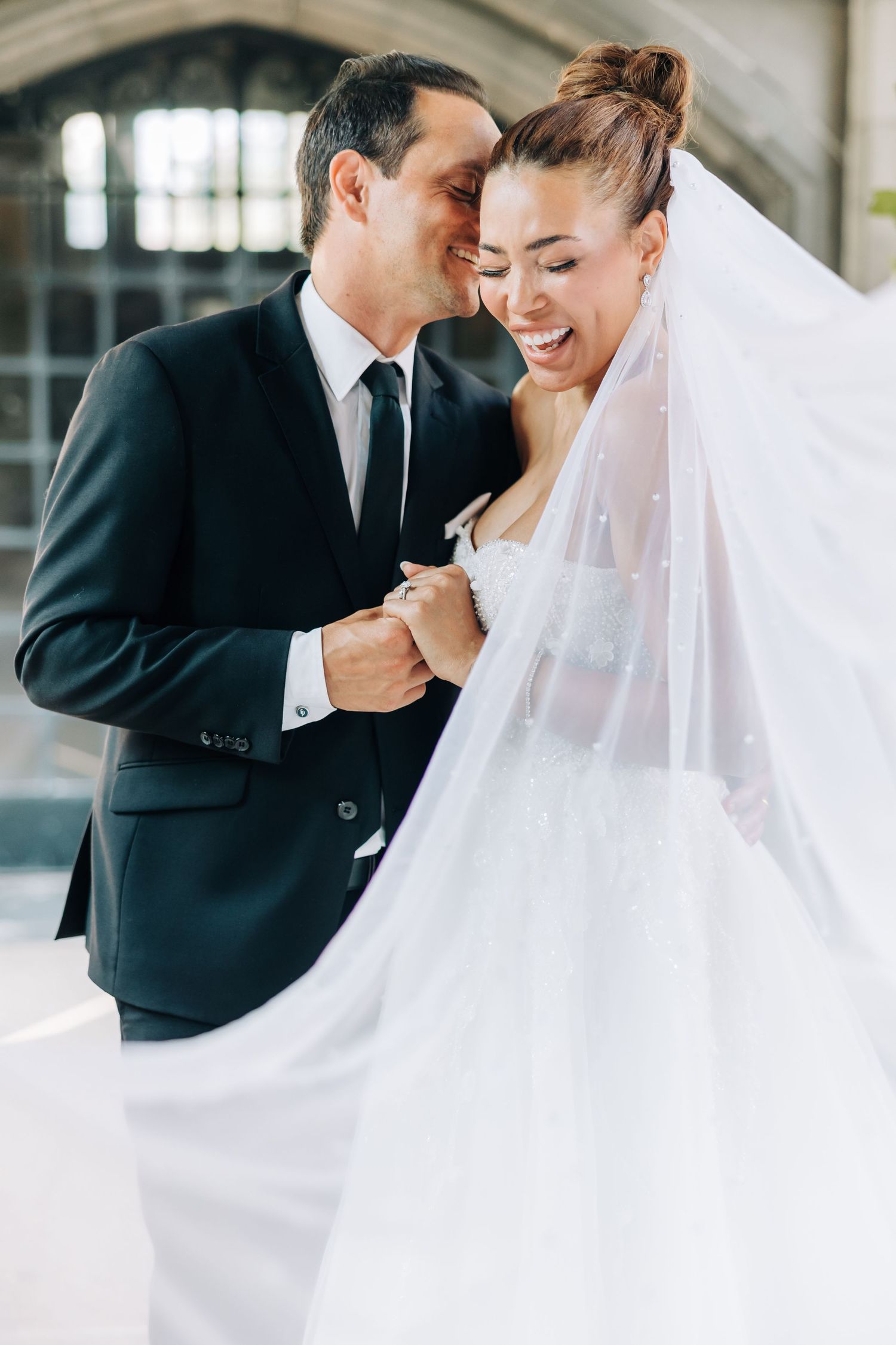 A tender wedding moment captured between newlyweds sharing an intimate embrace.