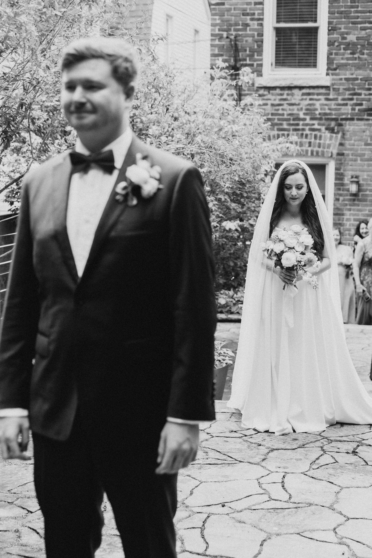 Black and white first look moment between couple before their wedding ceremony.