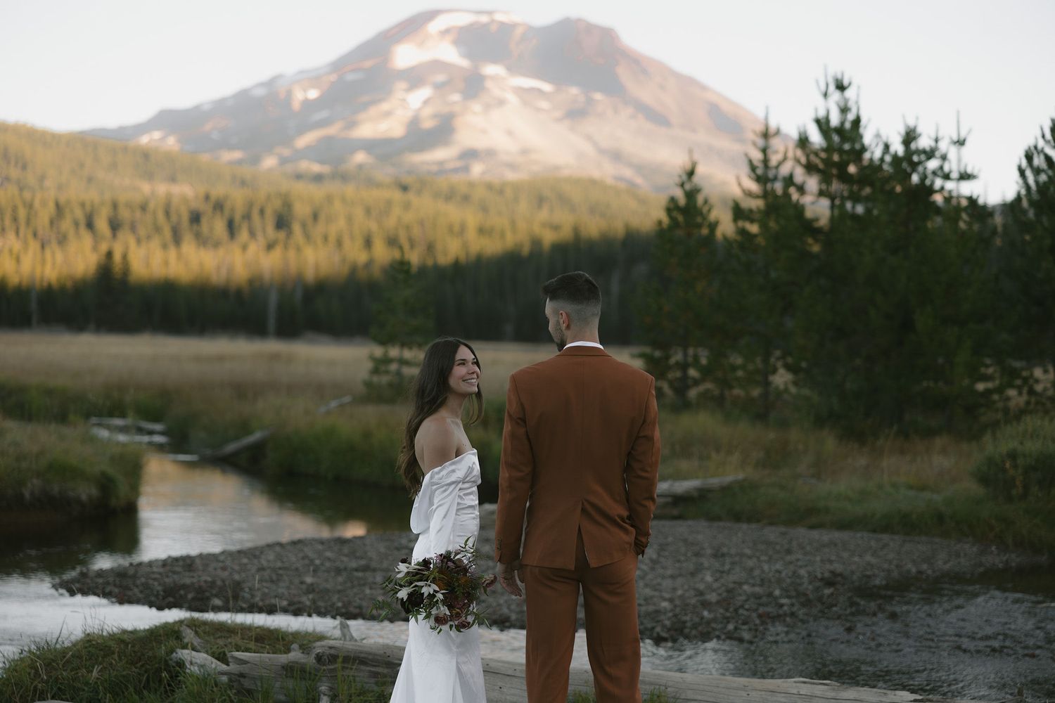 A mountain in the background with Oregon model couple in the foreground during an elopement shoot.