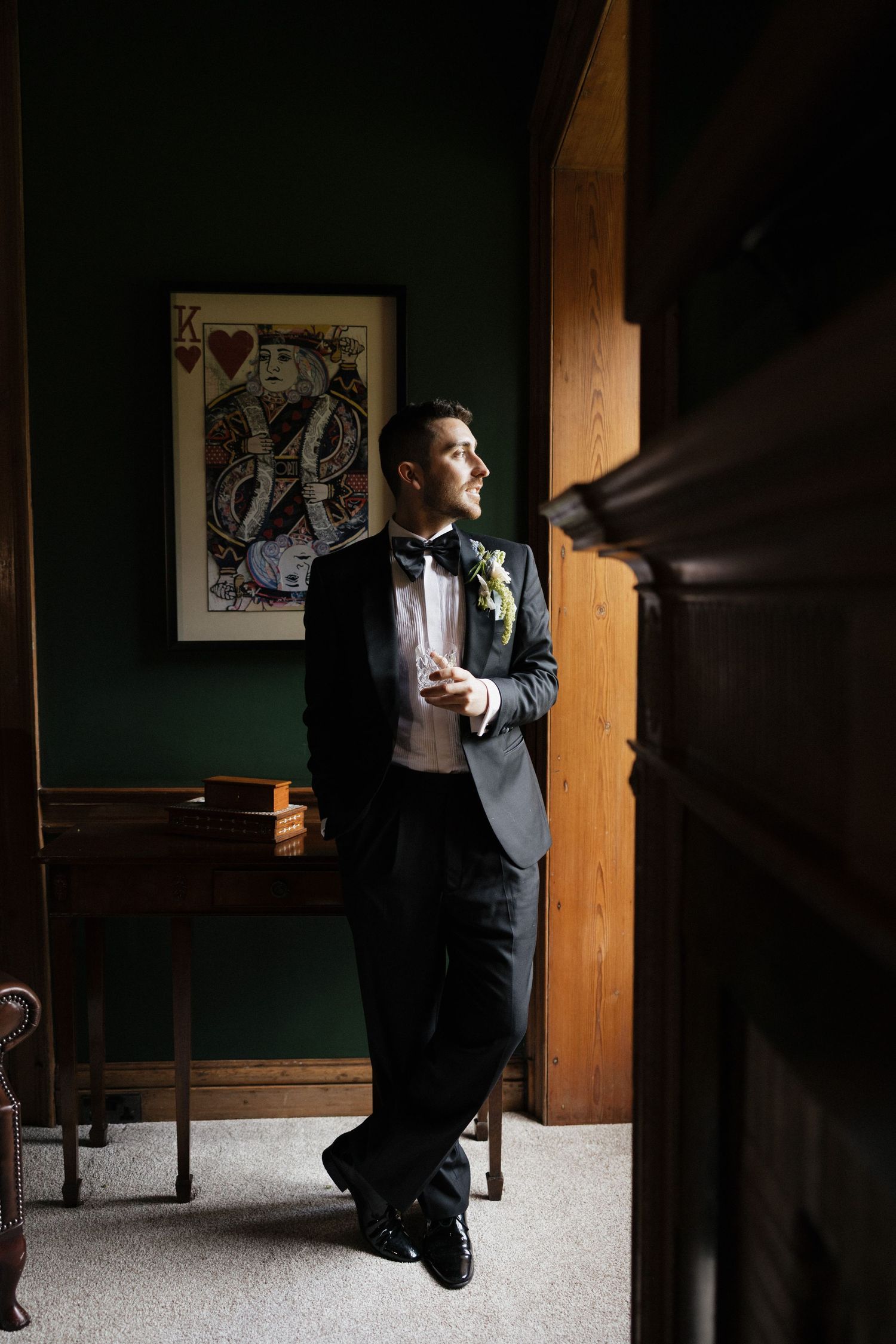 A sequence of dramatic black and white photos showing someone in a suit looking out a rustic wooden window.