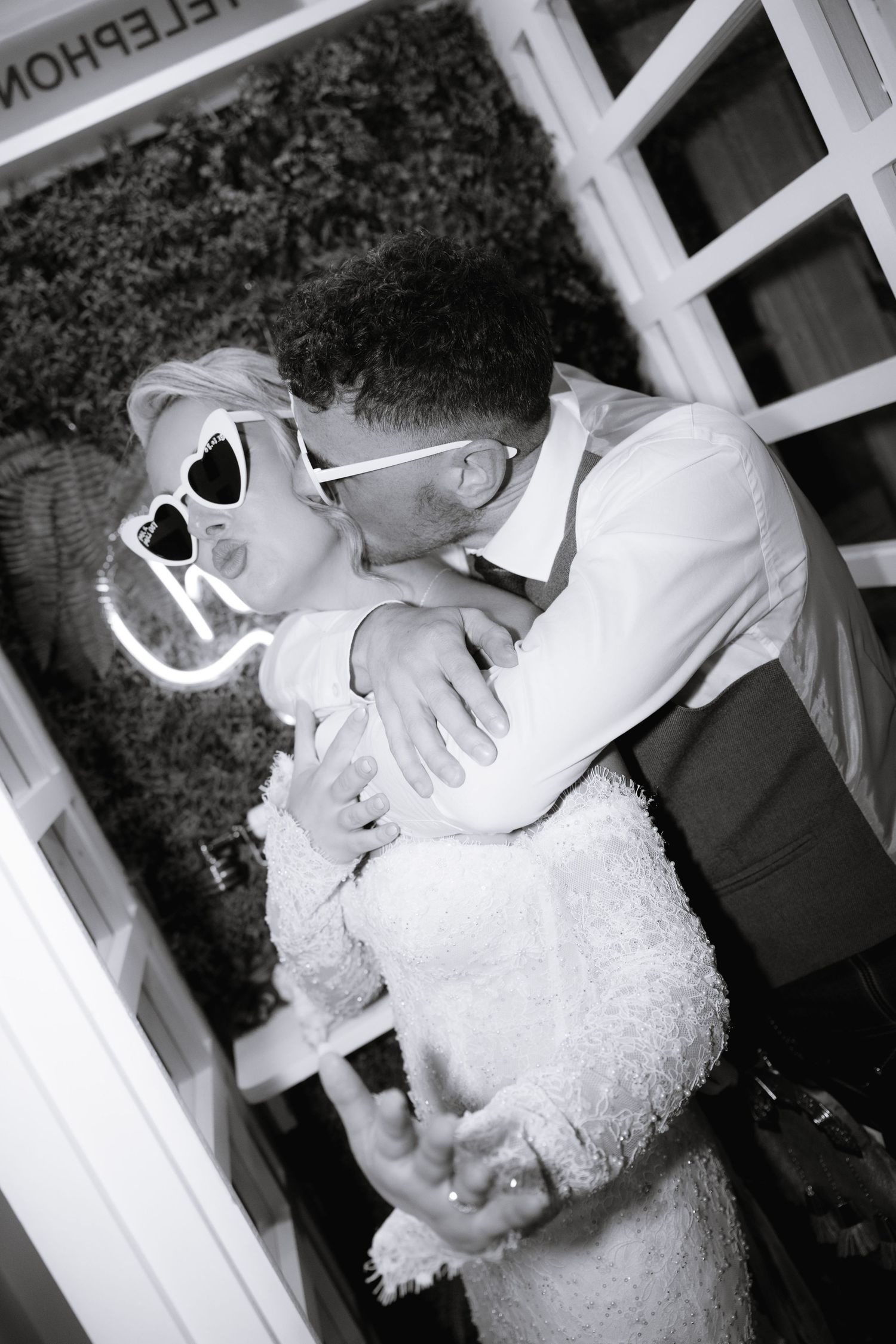 A sequence of black and white romantic wedding photos showing intimate moments between a couple.