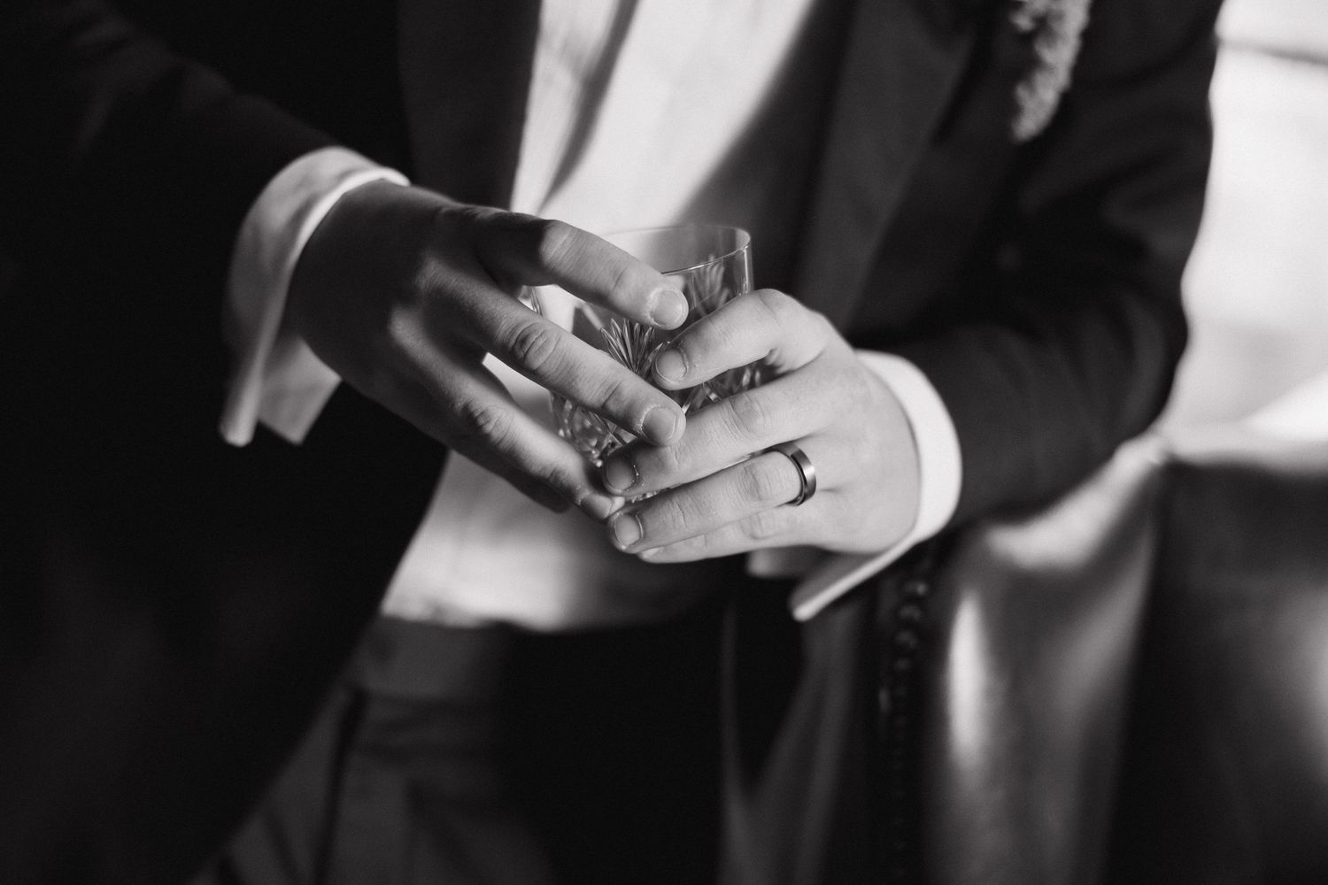 Black and white photo series showing hands exchanging wedding rings during a ceremony.