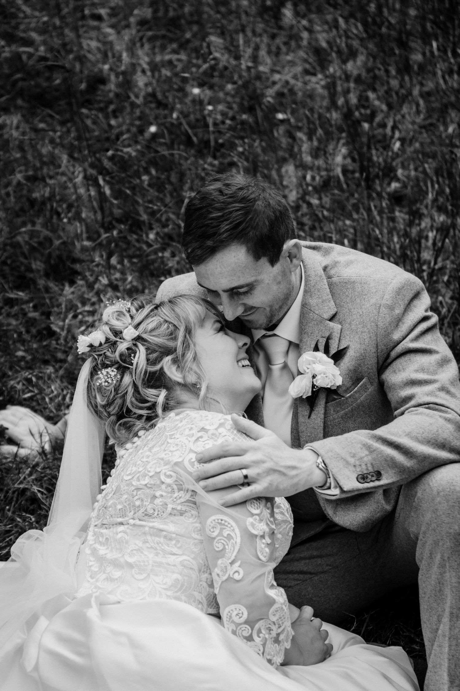 Black and white romantic wedding photo sequence showing couple in formal attire sharing an intimate kiss outdoors.