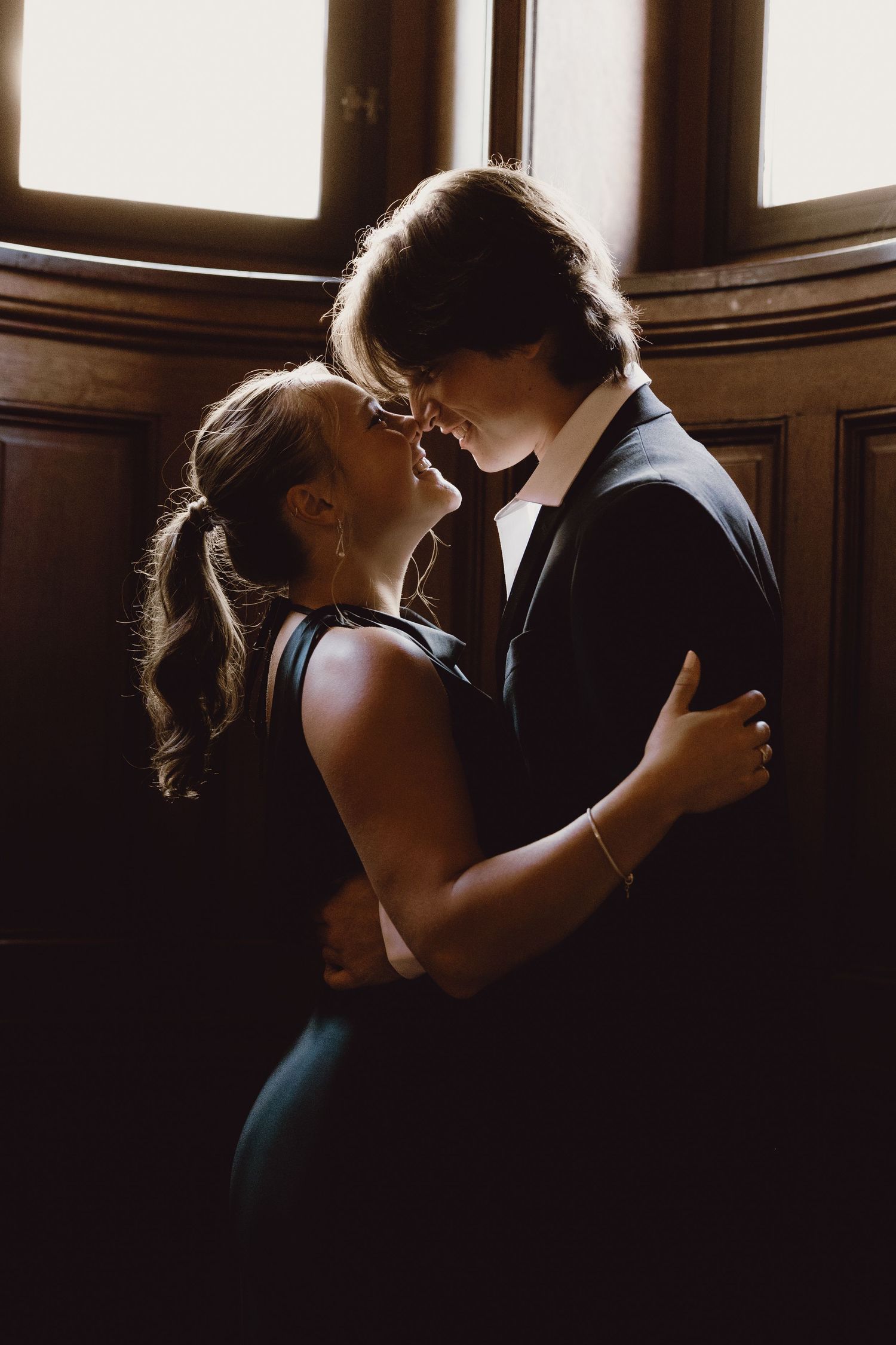 A romantic silhouette of a couple embracing in front of a window, creating a warm and intimate atmosphere.