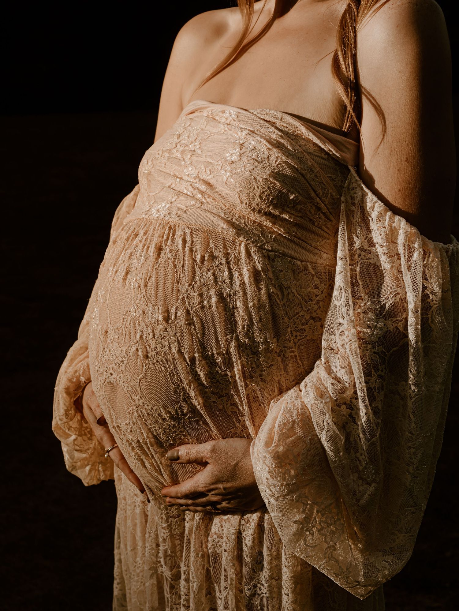 A series of sepia-toned artistic photographs showing a pregnant woman's belly in delicate lace maternity wear.