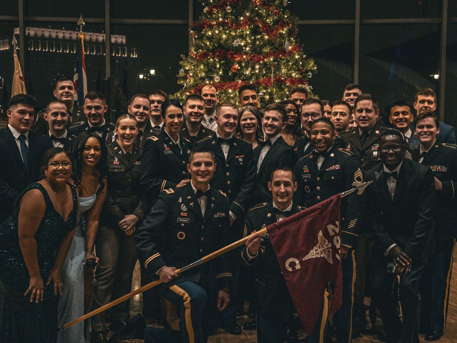 Large group photo of military personnel and guests at a holiday celebration.
