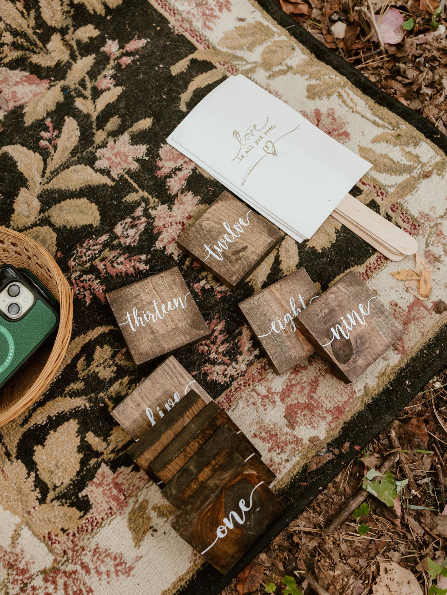 Wedding stationery and calligraphy items arranged artistically on a textured surface.