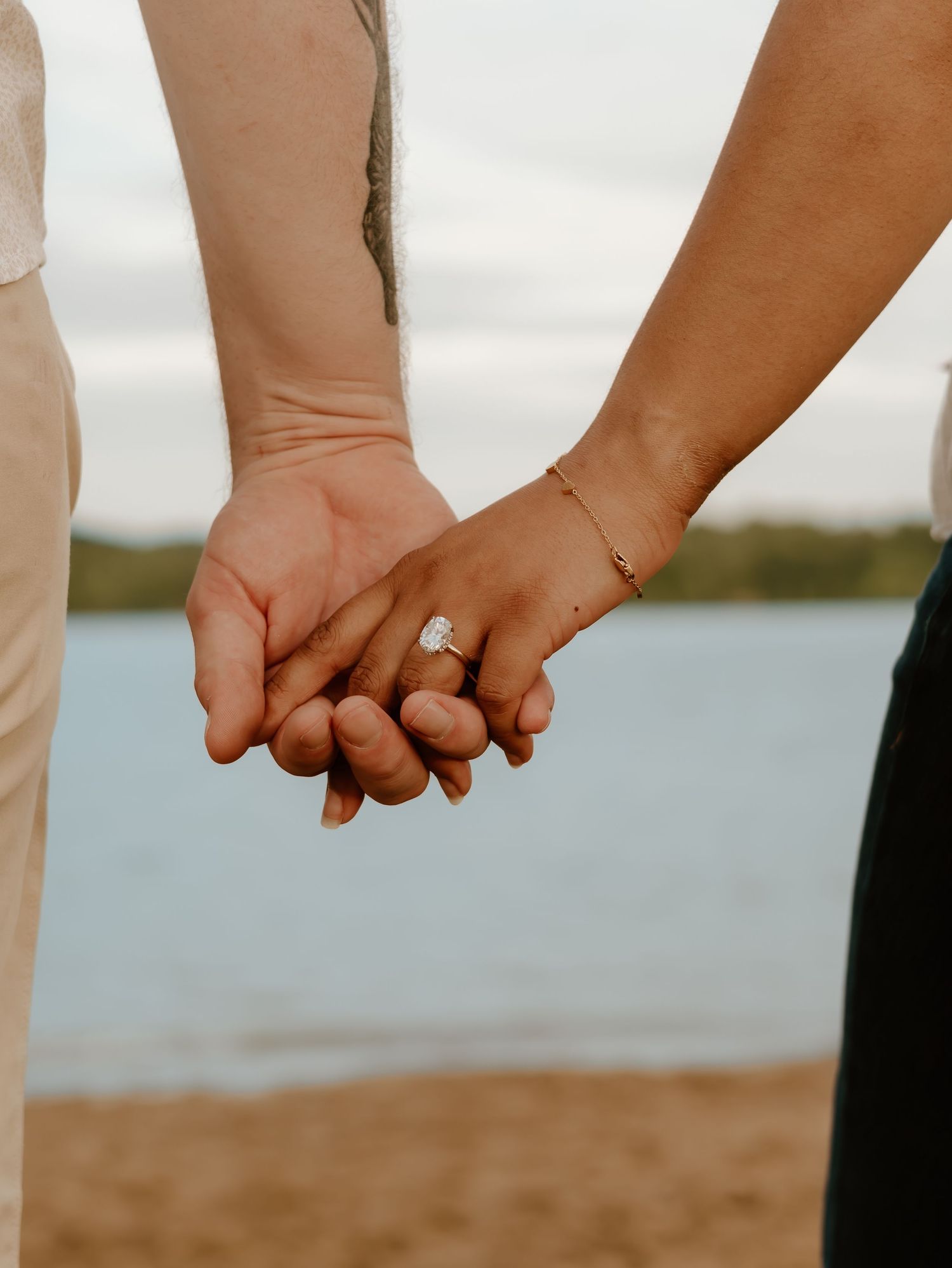 Multiple close-up shots of intertwined hands with engagement rings against a waterfront background.