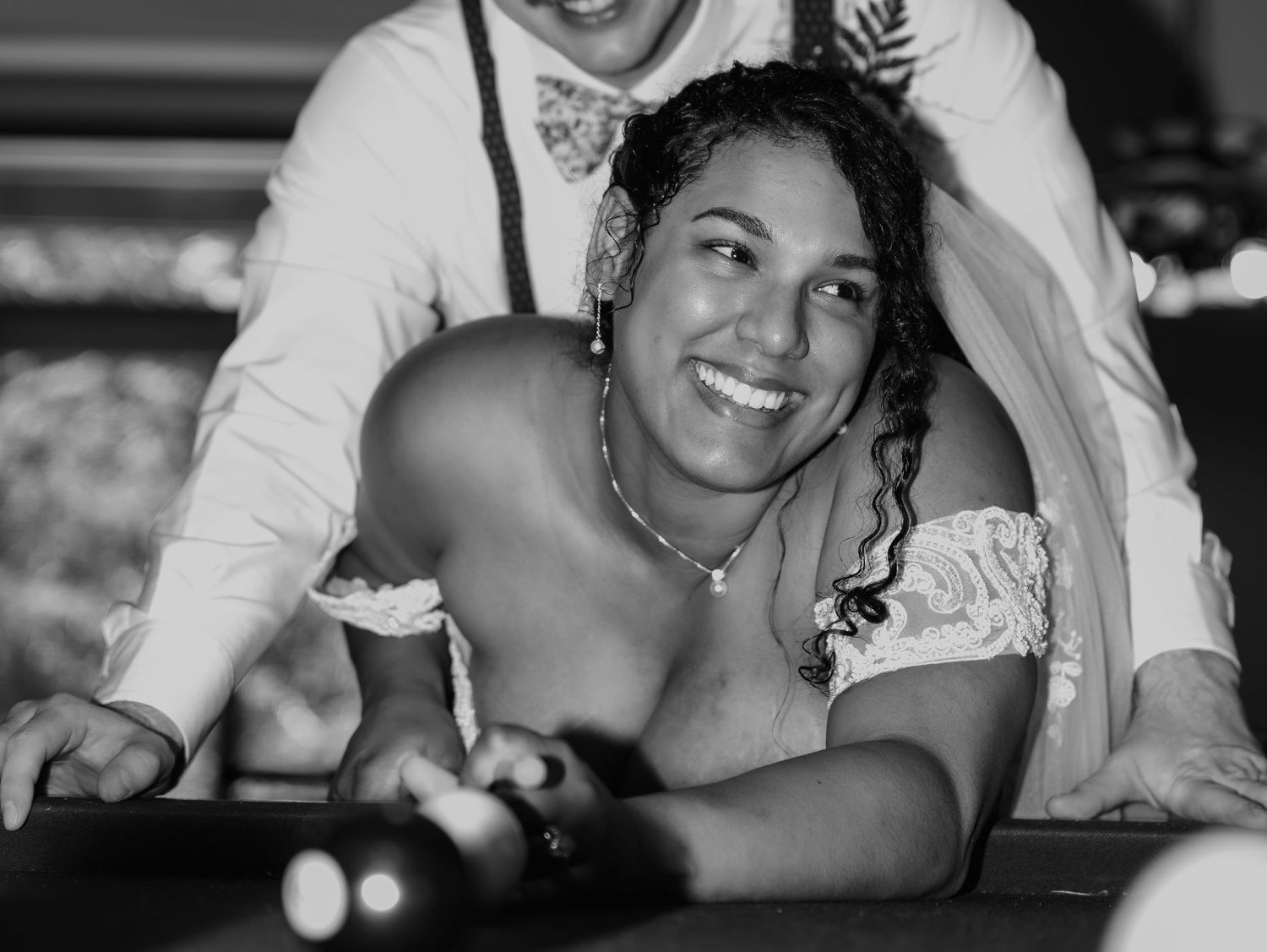 Black and white candid wedding photos showing joyful laughter and intimate moments.