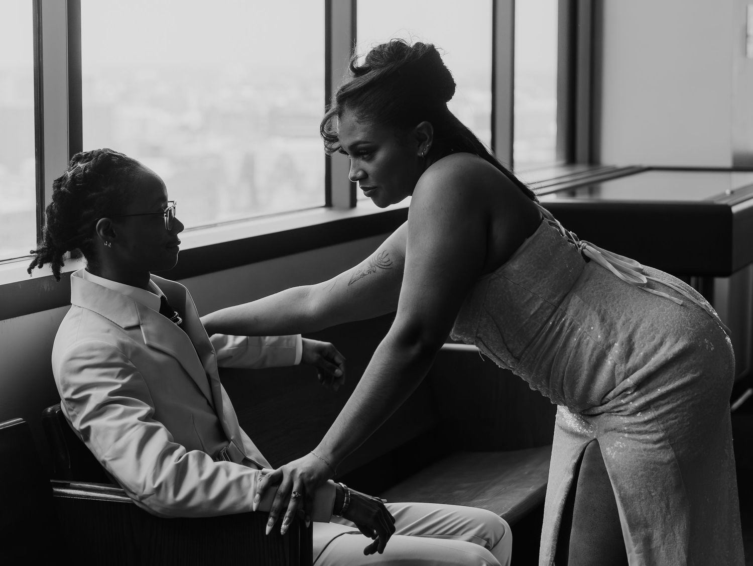 A series of black and white photos showing intimate moments of a couple dancing and embracing near a window.