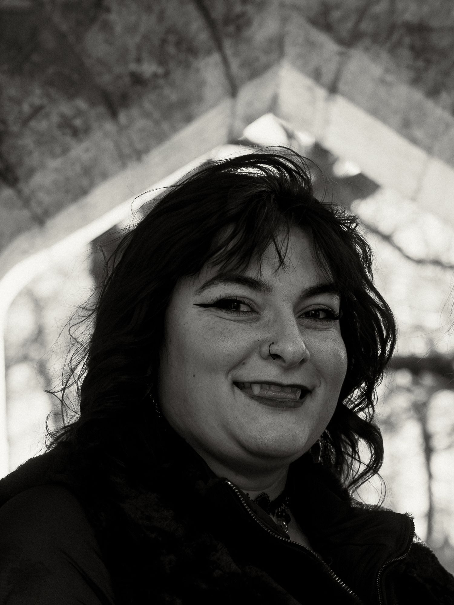 A series of black and white portraits showing expressive emotions and different angles of the same person.