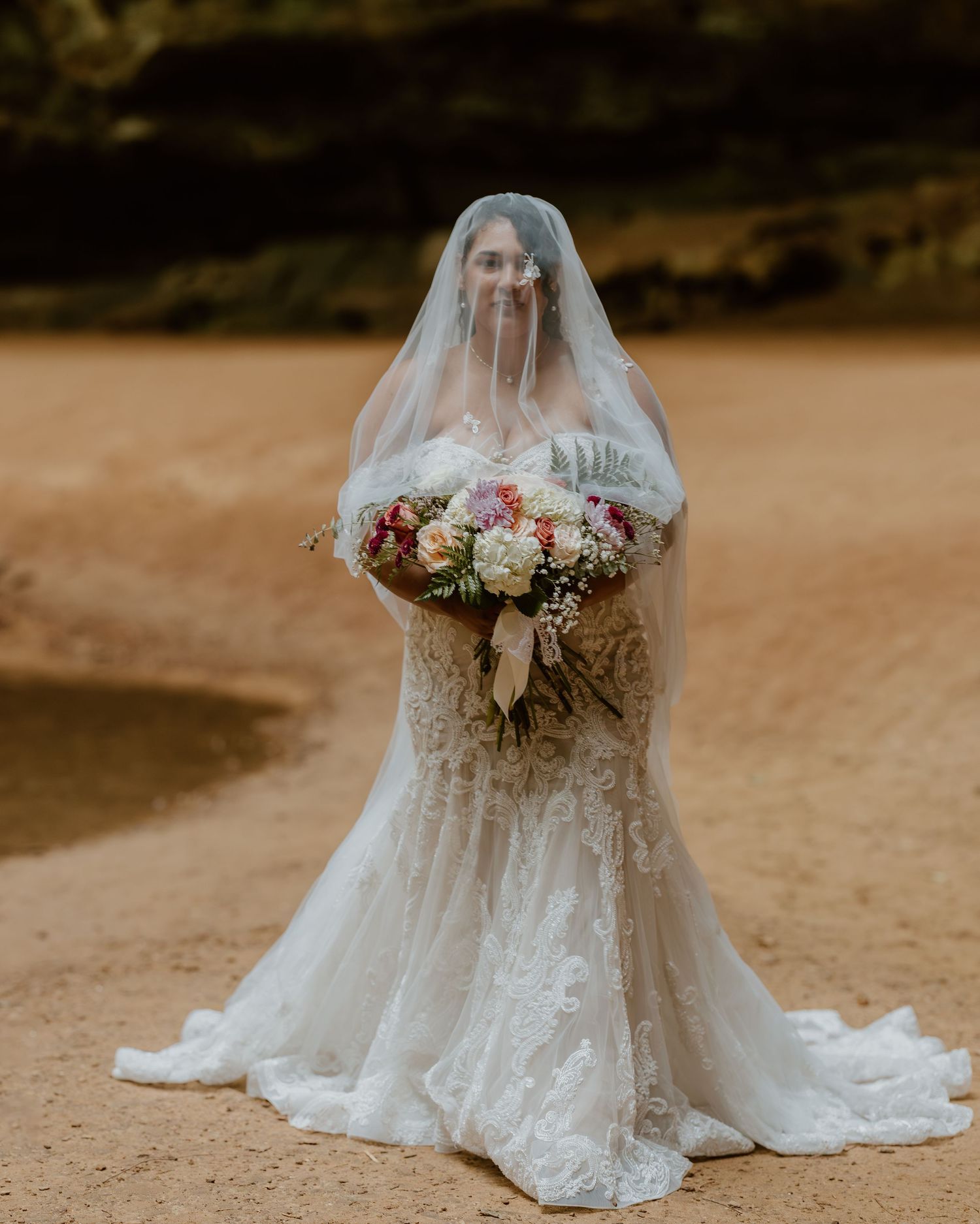 A series of elegant wedding dress details showing flowing white fabric, lace trim, and floral bouquets against a rustic backdrop.