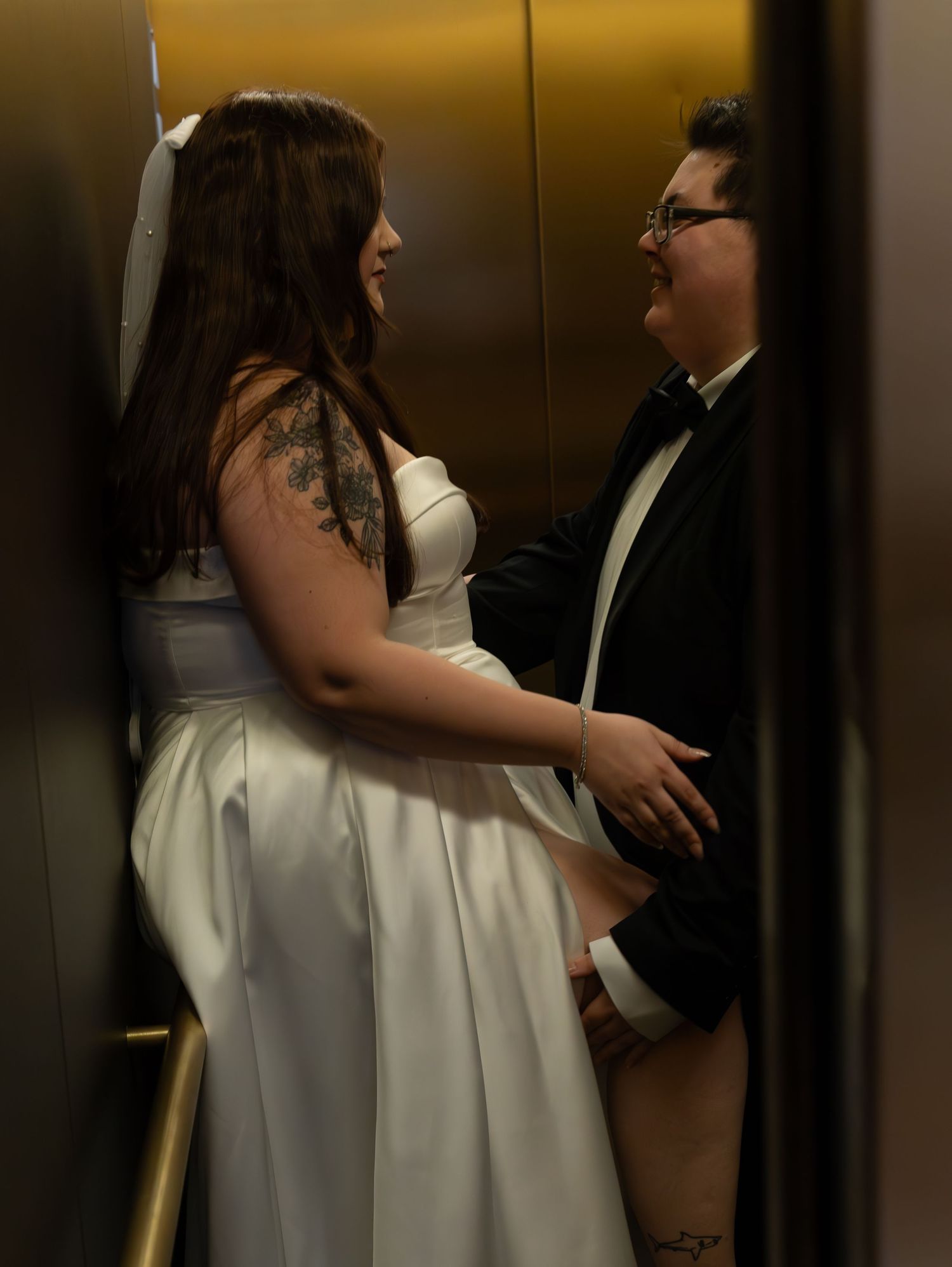 Group photo in an elevator showing people posing together in formal attire.