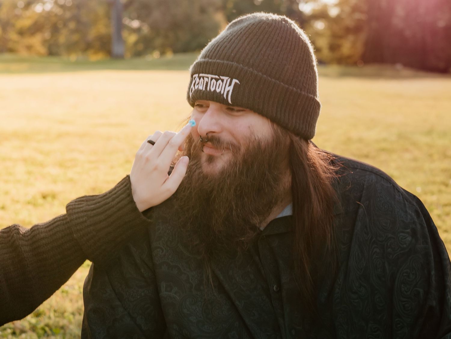 A person in a brown beanie cap is shown in multiple angles against a warm sunset background outdoors.