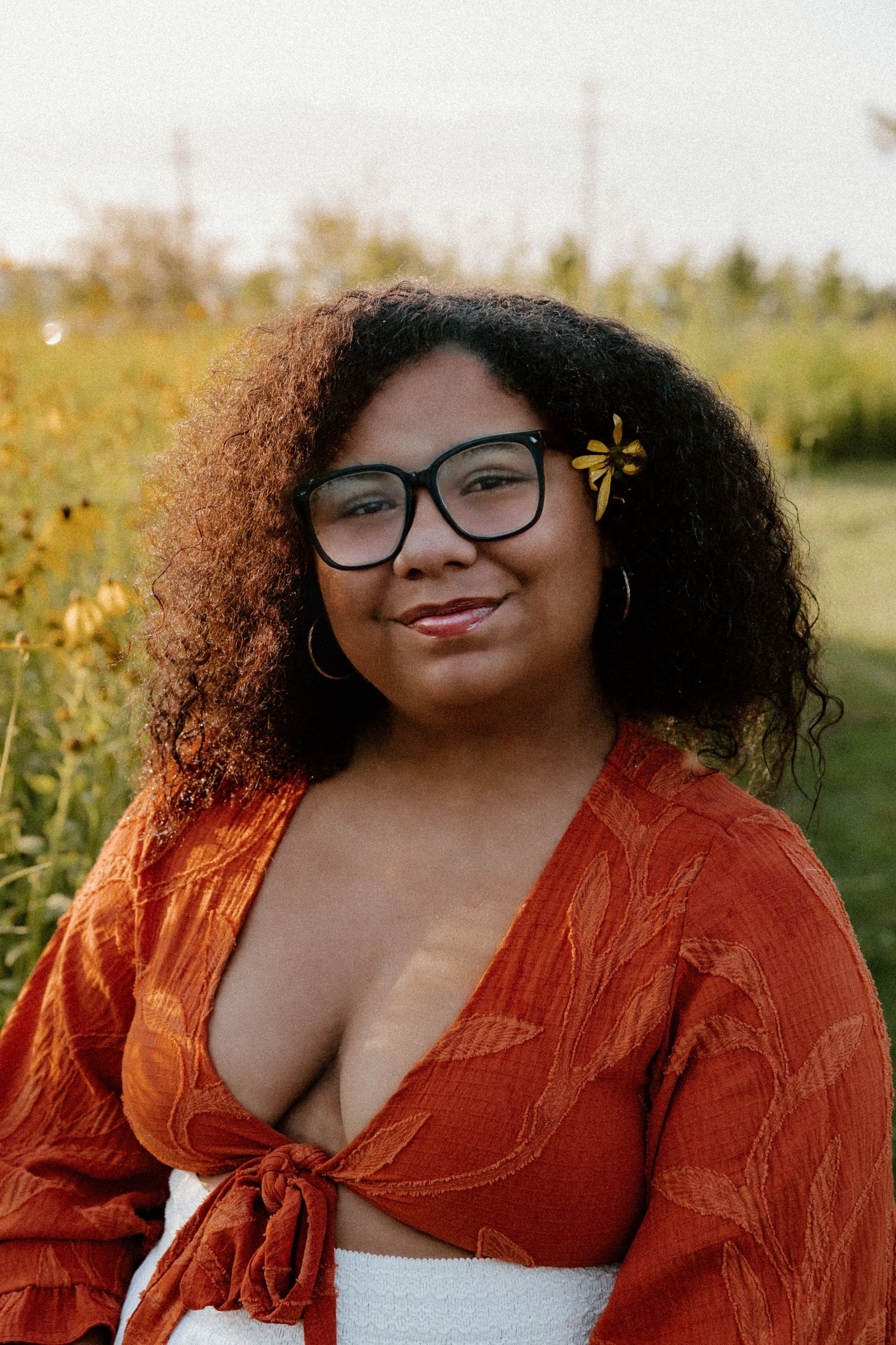 Person in an orange top poses outdoors in a series of warm sunset portrait shots against natural foliage background.