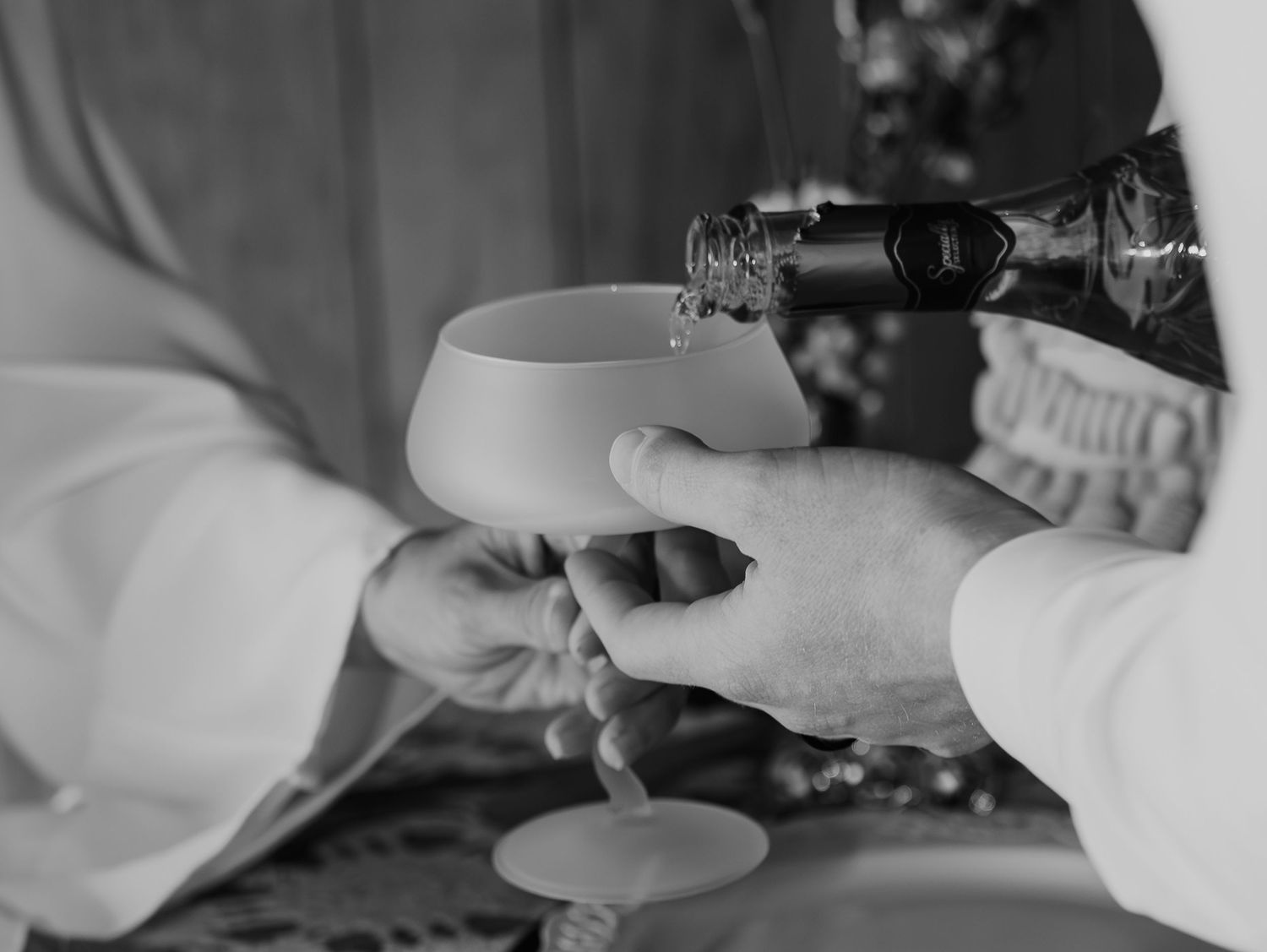 Medical professional wearing white protective gear performs sanitization or cleaning procedure in clinical setting.