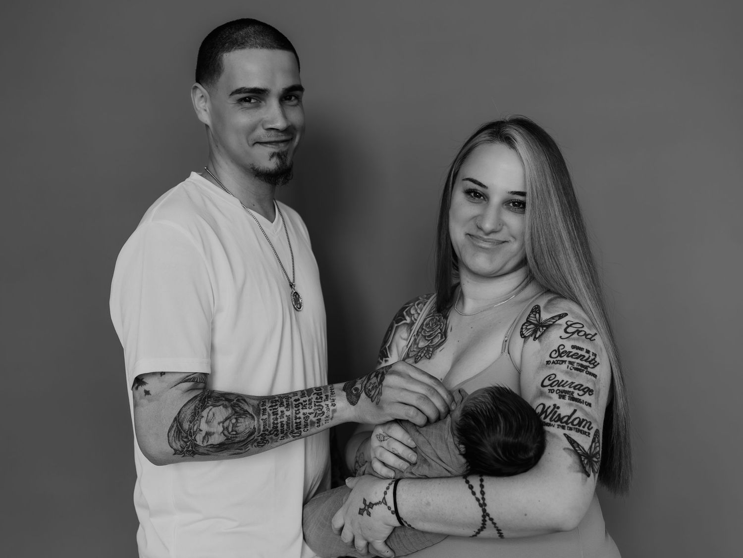 A series of black and white photographs showing couples embracing and displaying their matching tattoos.