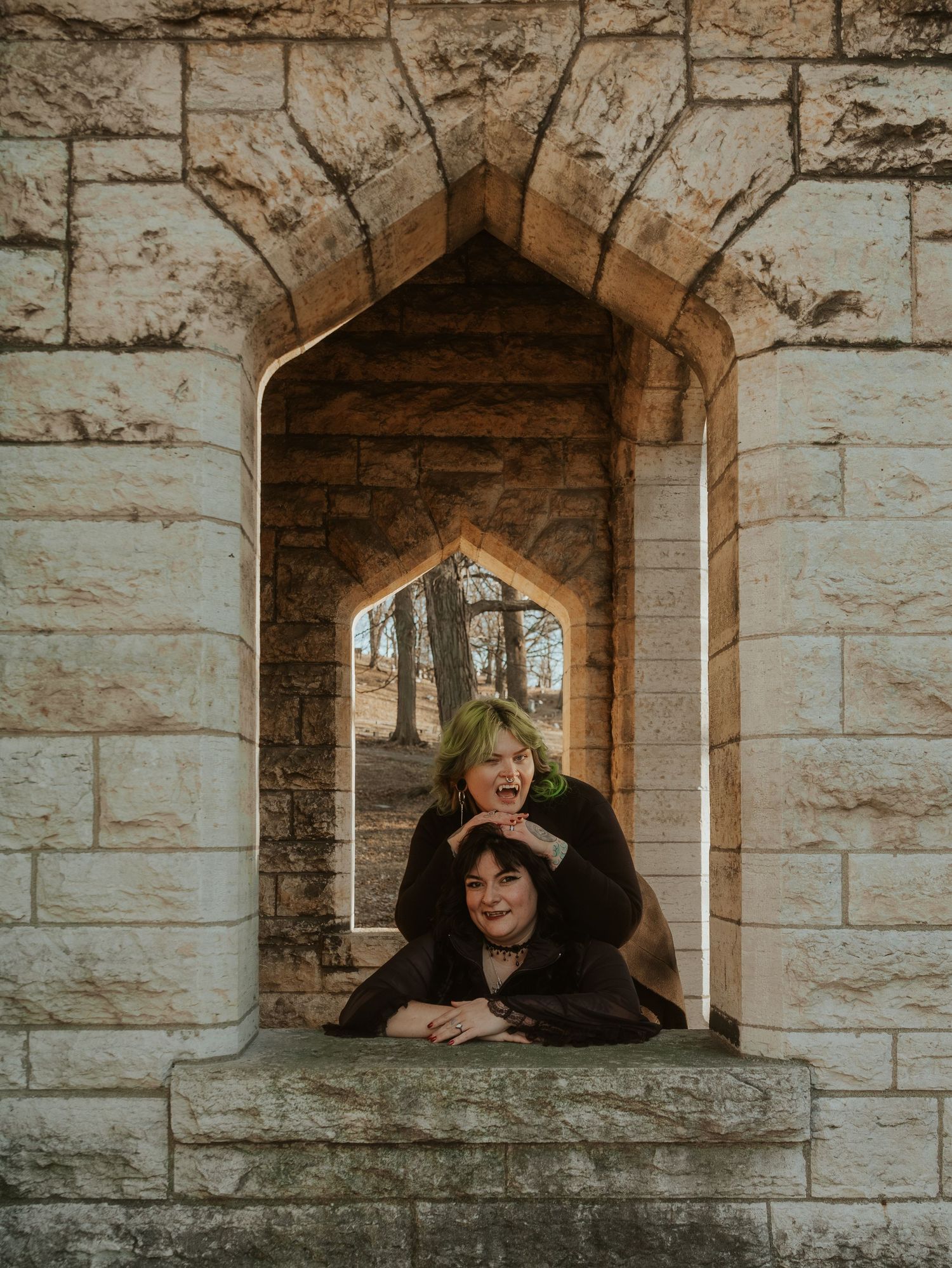 Stone archways frame a gothic architectural scene with dramatic lighting and shadows.