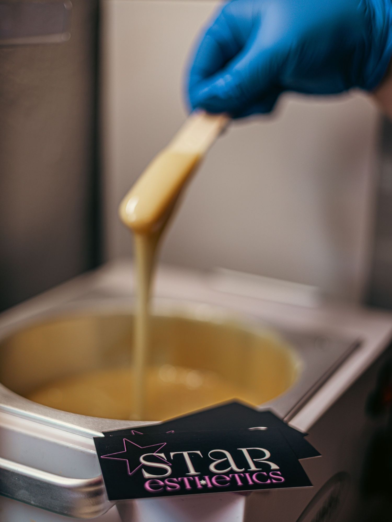 Laboratory testing equipment with golden liquid samples being processed in sterile conditions.