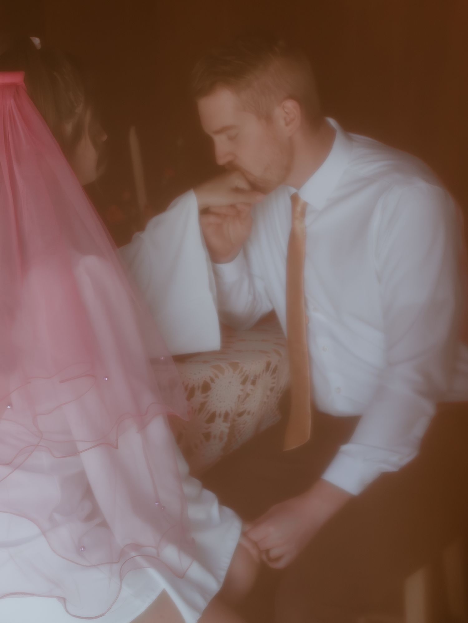 A vintage-style photograph series captures intimate moments at a wedding reception with soft pink and brown tones.