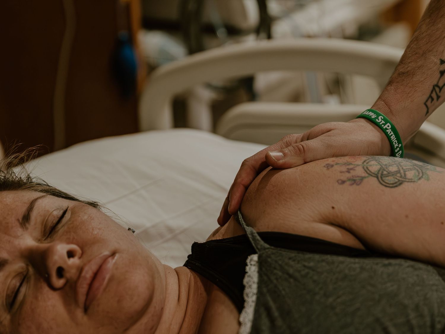 Patient lies on a hospital bed while receiving medical care during a peaceful moment.