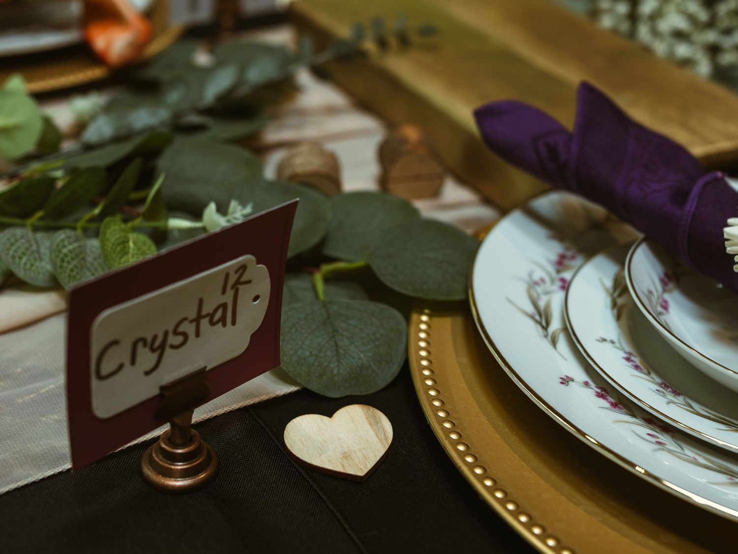 Elegant table setting with dark place cards and decorative elements for a formal dinner event.