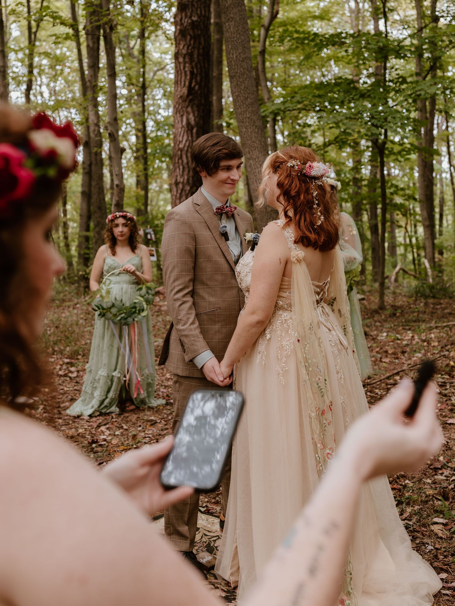 A romantic woodland wedding scene with bridesmaids in mint green dresses and vintage-inspired decor.