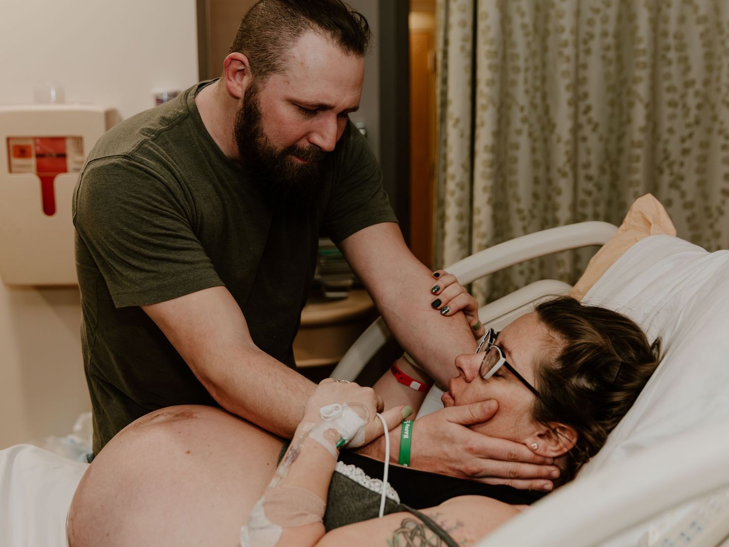 Medical staff providing care and monitoring vital equipment during a patient's labor and delivery.