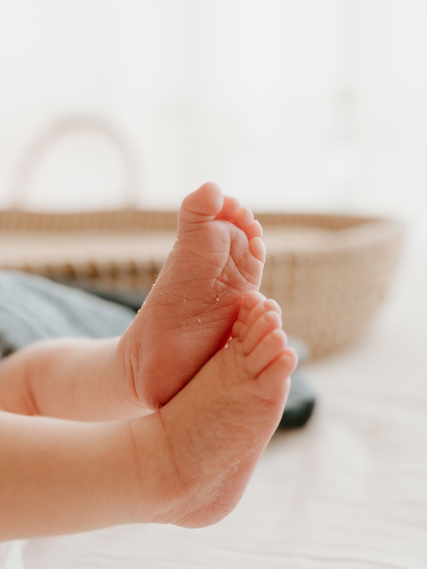 Close-up series of a baby's tiny feet showing different angles against a soft white background.