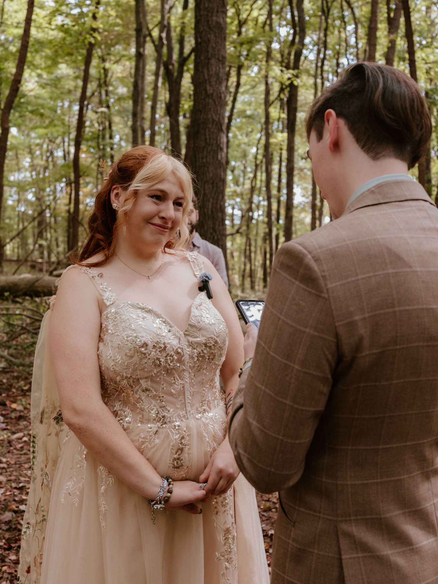 A wedding ceremony sequence showing emotional moments between a couple in a sunlit forest setting.