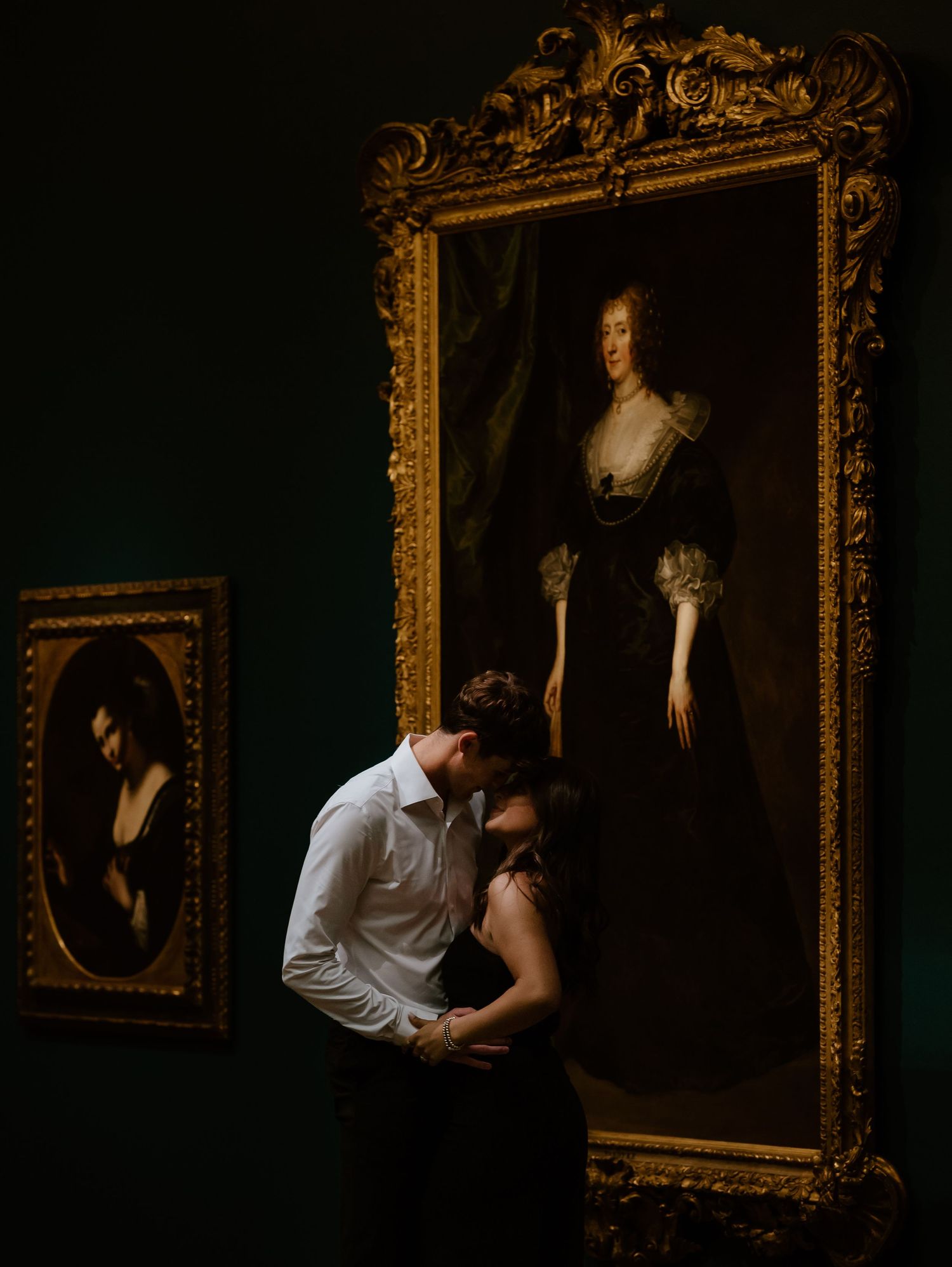 A romantic photoshoot at a vintage art gallery shows a couple in intimate poses, surrounded by ornate framed portraits.