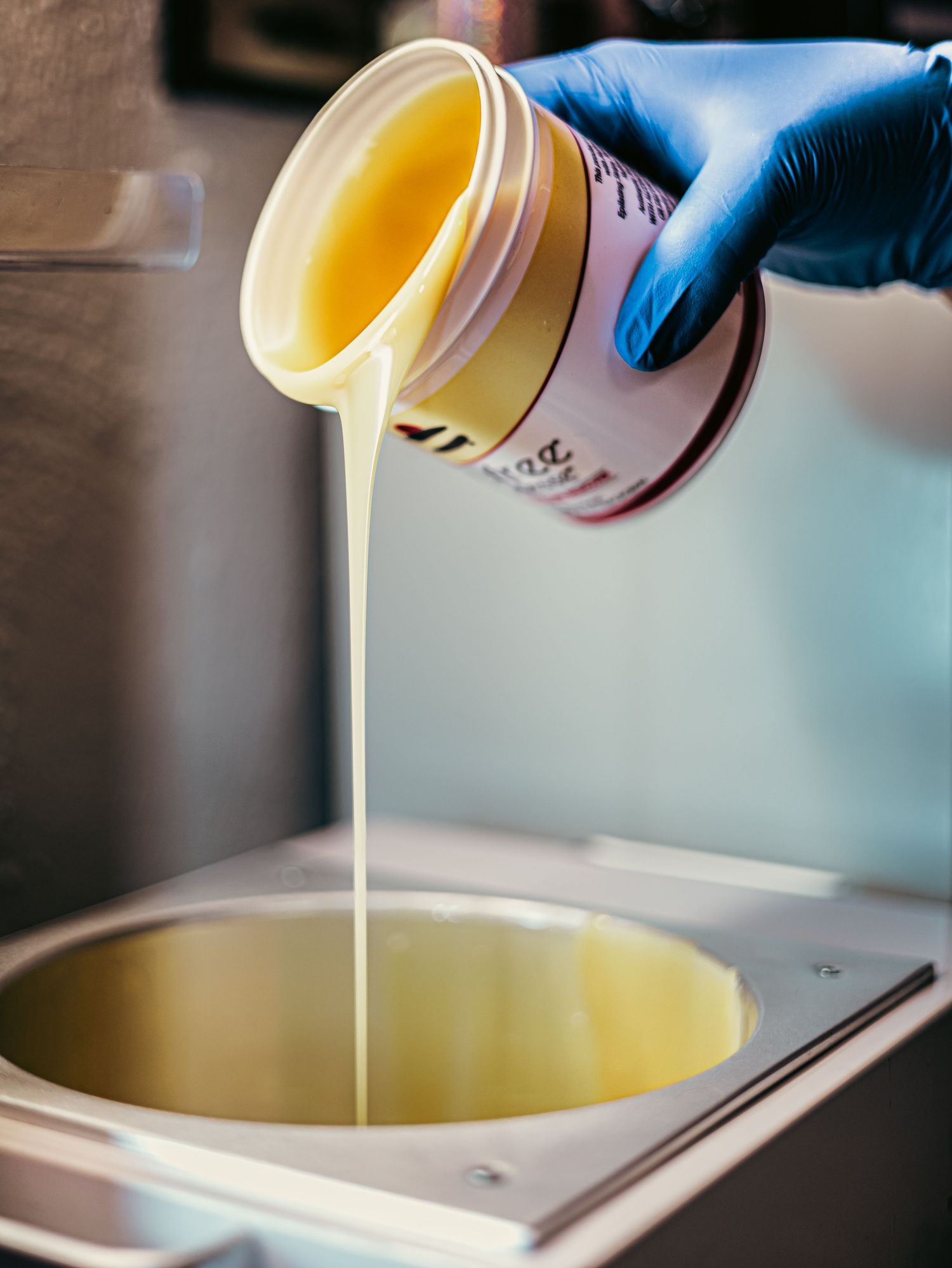 A series of close-up shots showing liquid white resin being poured into a mold in sequential steps.