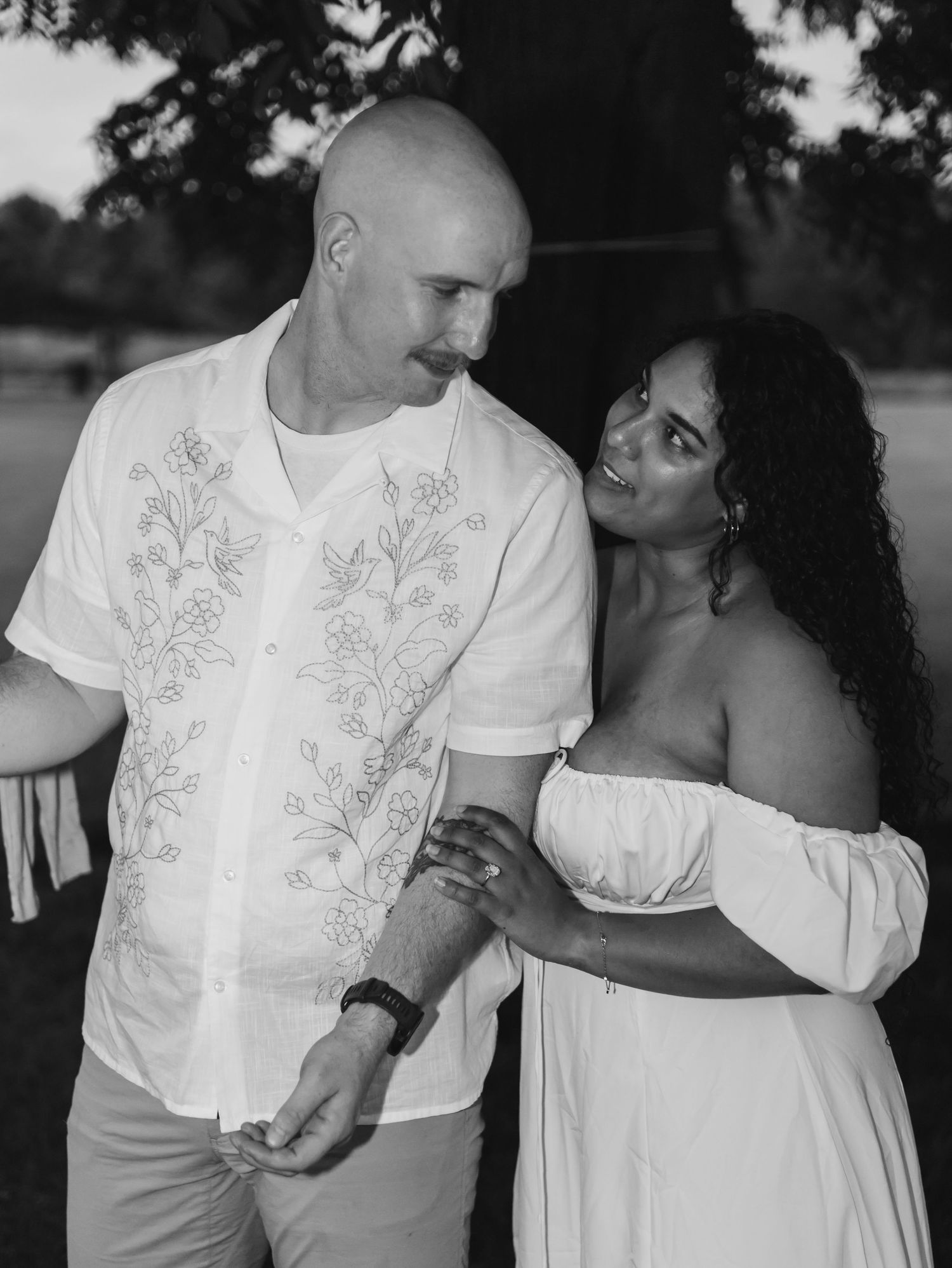 A couple in wedding attire share an intimate dance together during their celebration.