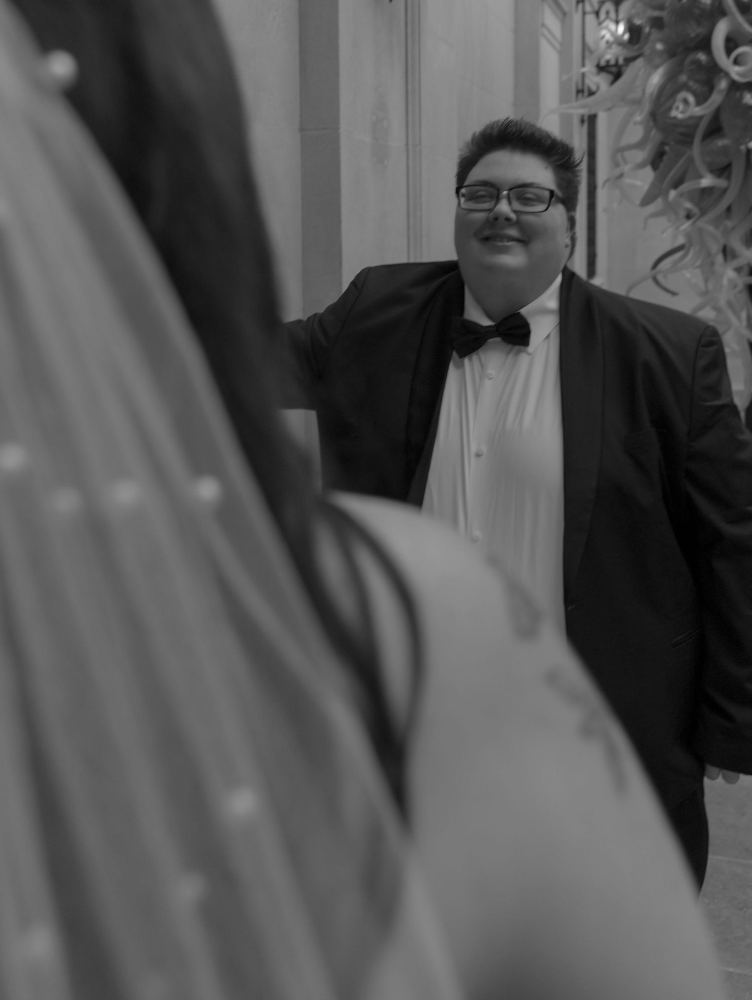 Wedding guests smile and celebrate during a joyous reception.