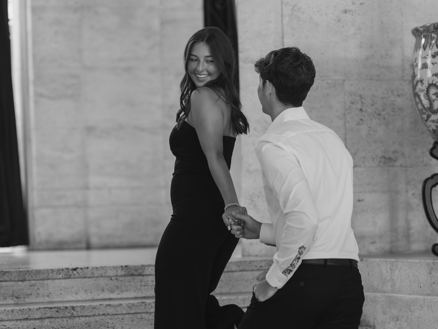 A sequence of black and white photos showing a couple dancing together in an elegant setting.