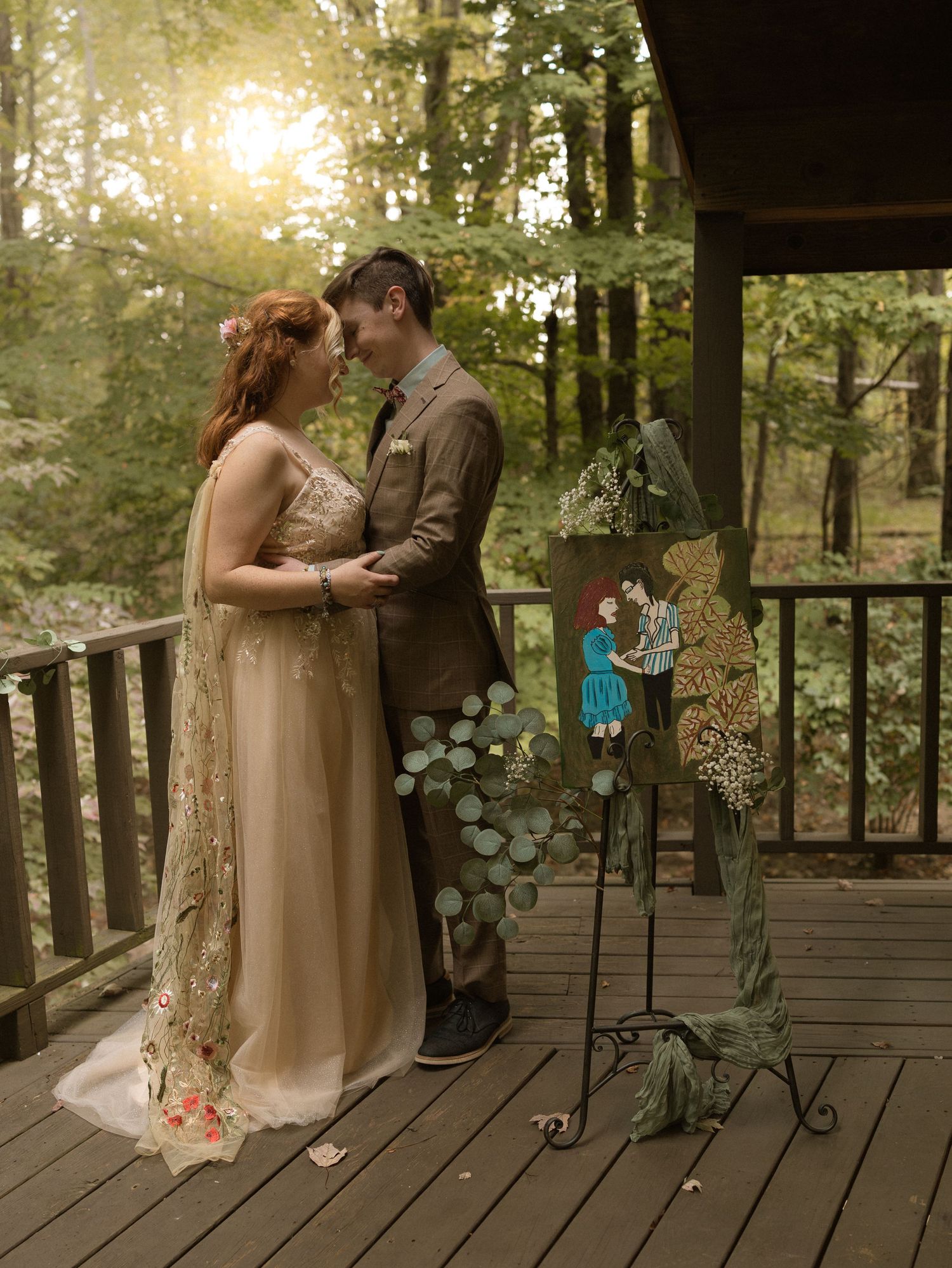Intimate romantic moment shared between couple on rustic wooden deck during golden hour sunset in forest setting.