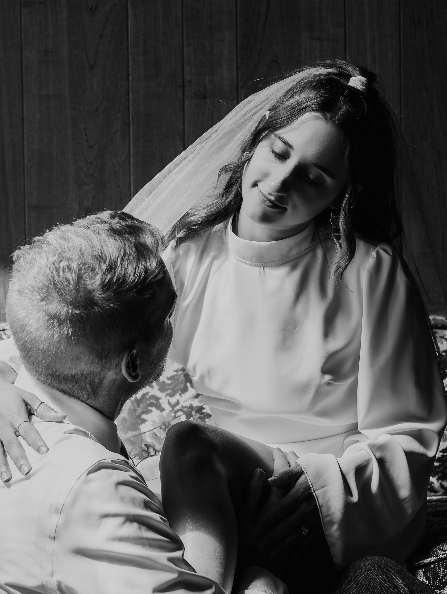A dramatic black and white series of photos showing a couple in romantic intimate poses against a dark background.