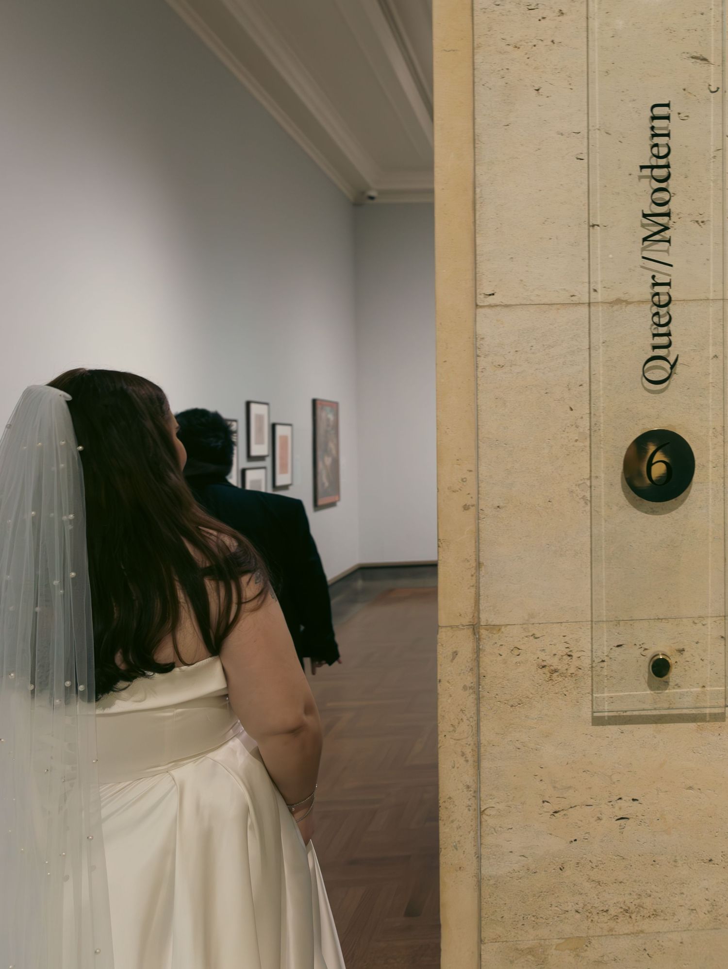 Wedding dress veil details shown in multiple angles against a light colored wall.