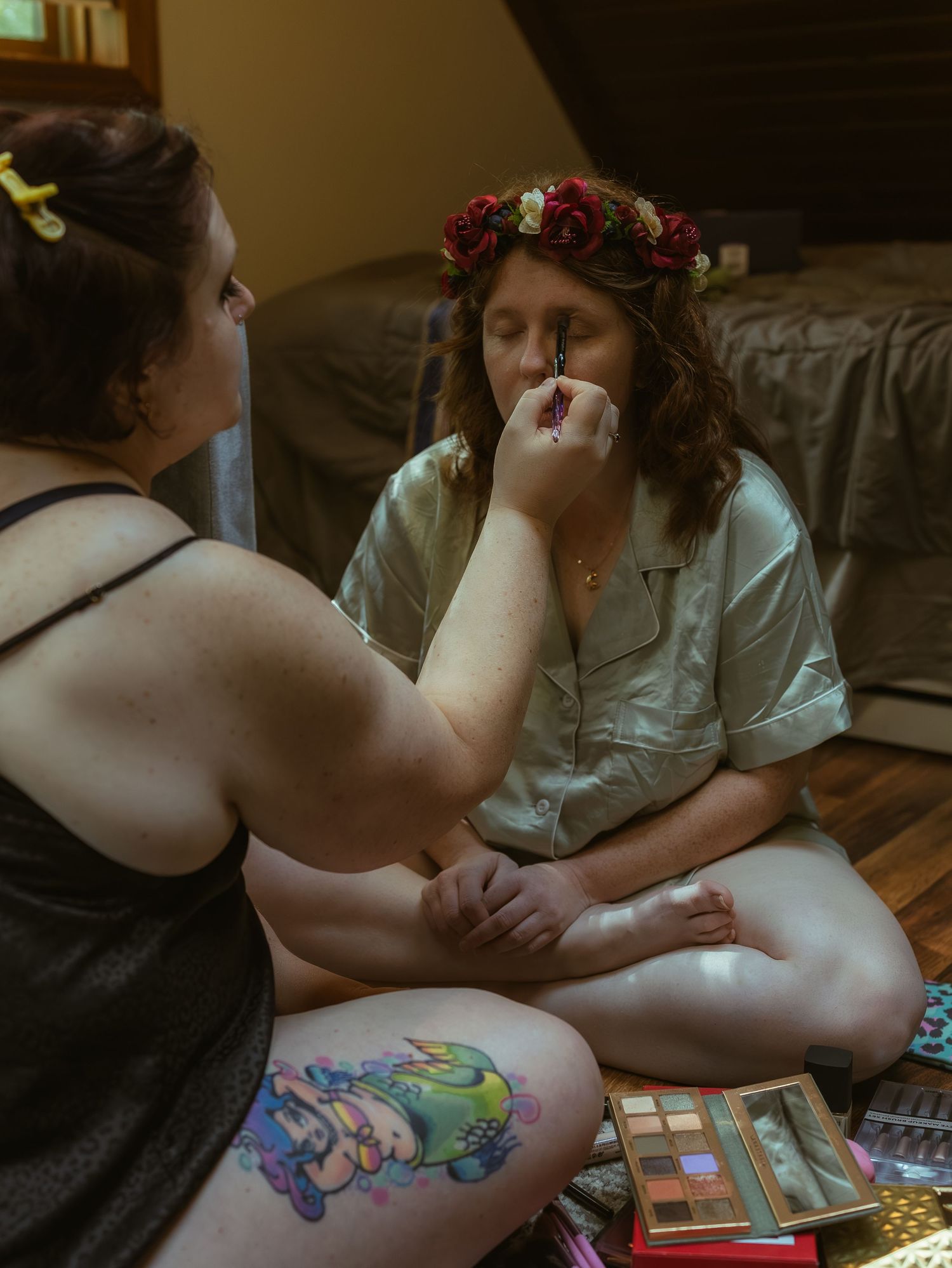 Person getting a colorful temporary tattoo or henna design applied to their arm in an artistic process.