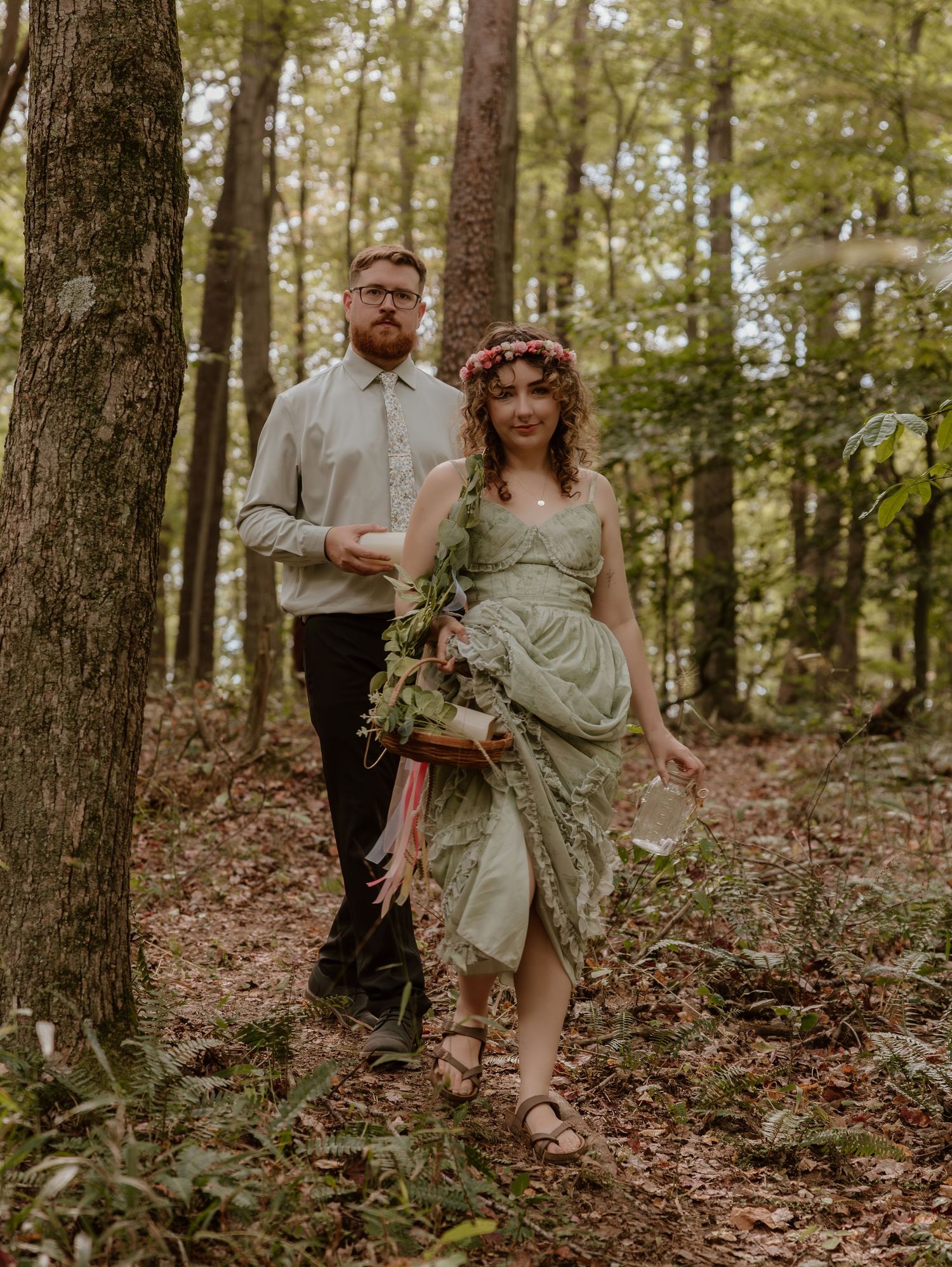 A series of romantic wedding photos taken on a wooded hillside with natural lighting.